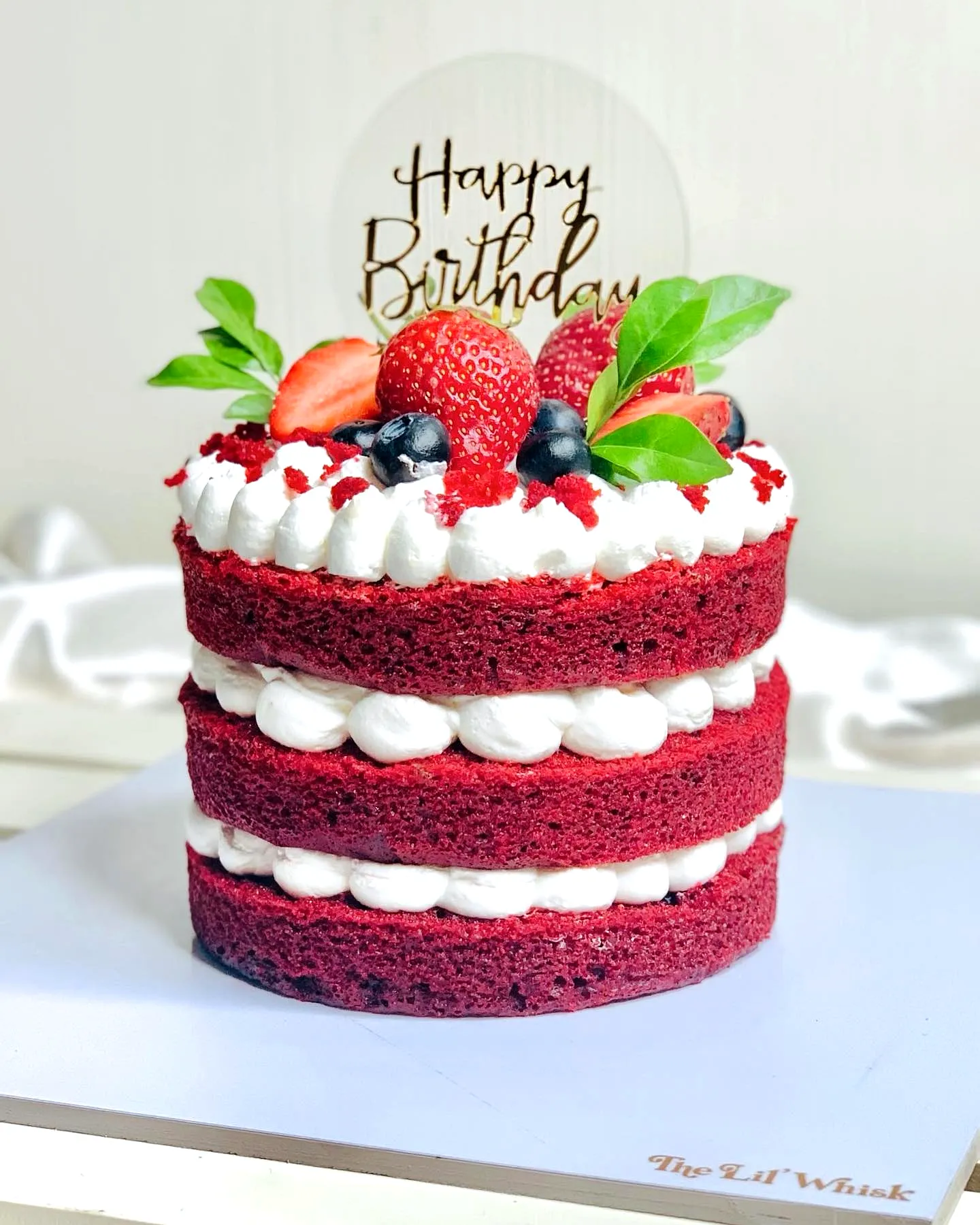 Creative red velvet birthday cake design with vibrant colors and fresh toppings