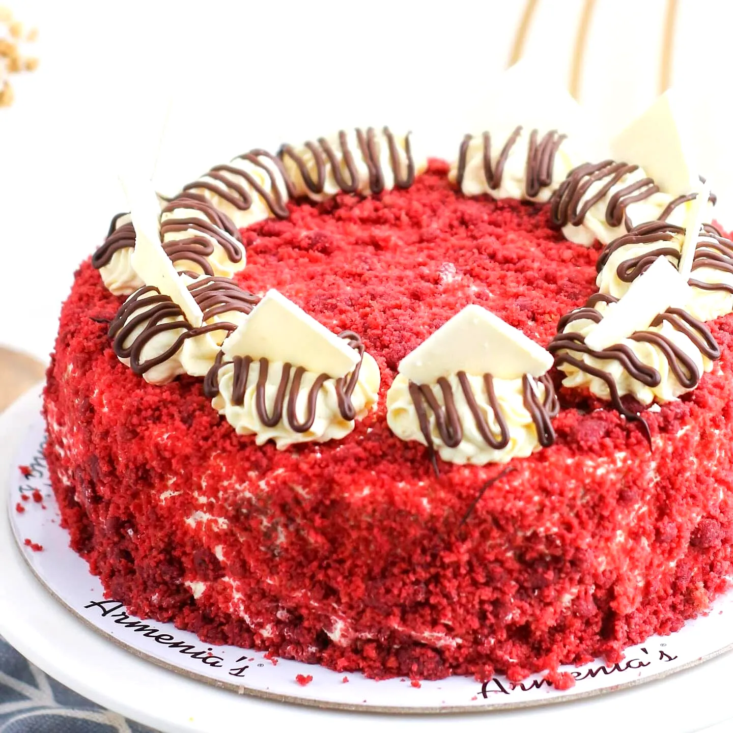 Creative red velvet birthday cake design with white chocolate and chocolate drizzle