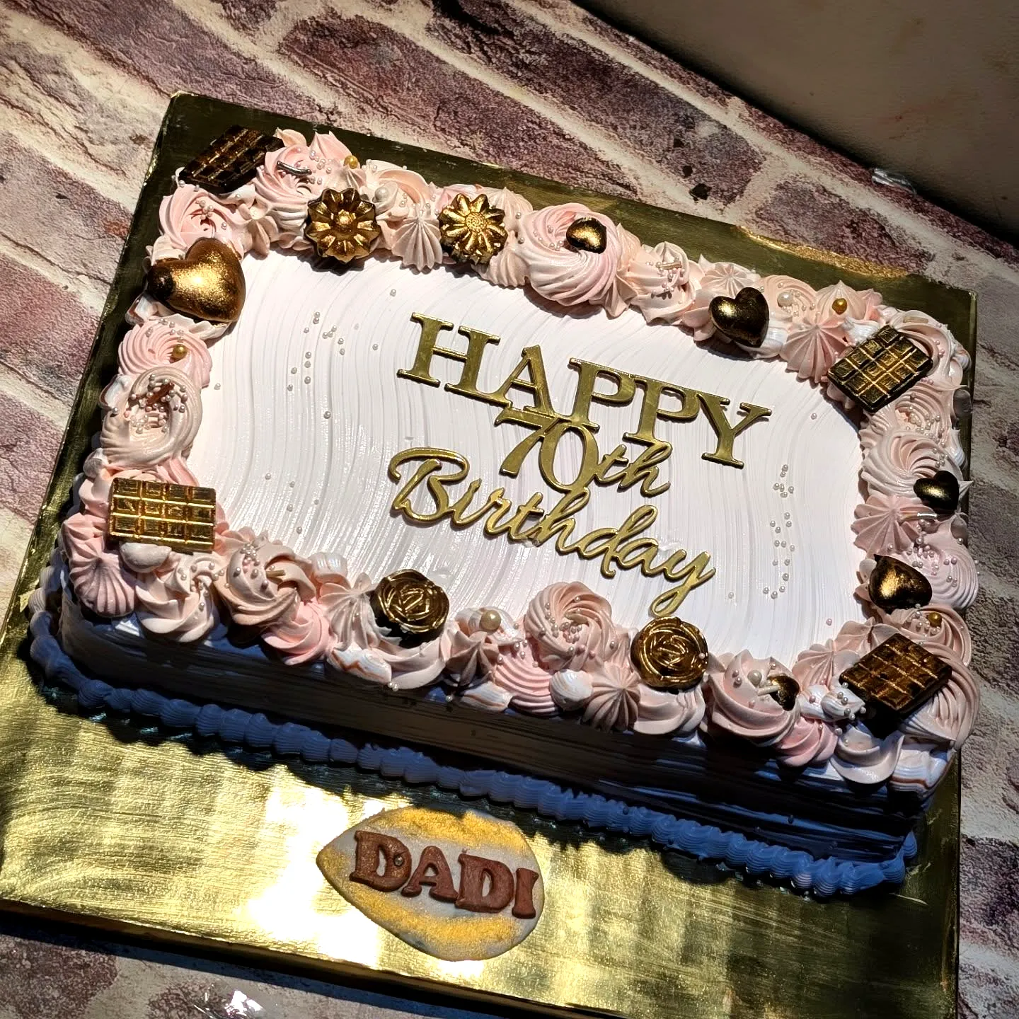 Cute 70th Birthday Cake with Pink Rosettes and Golden Touches
