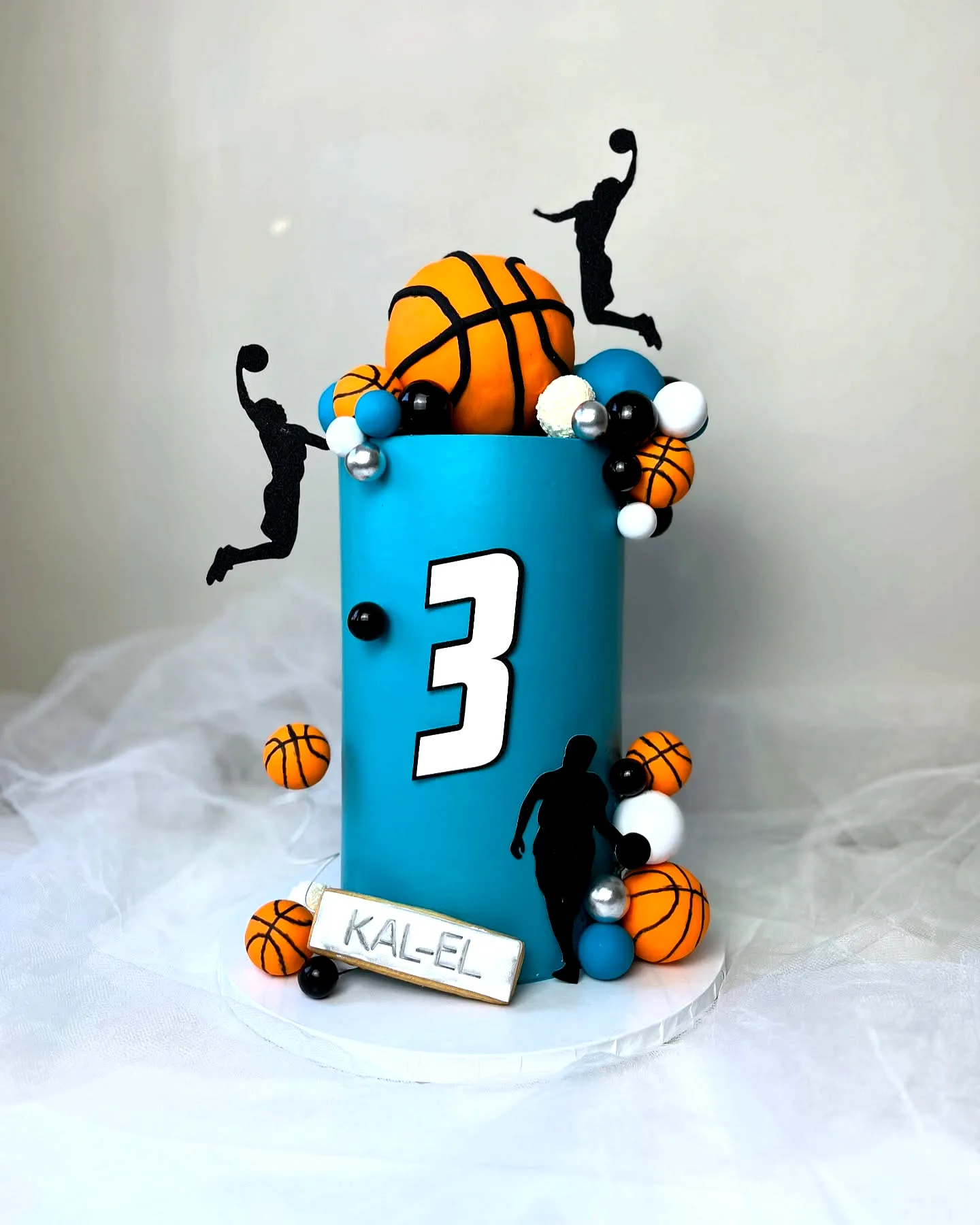 Cute basketball birthday cake design in vibrant teal for sports lovers