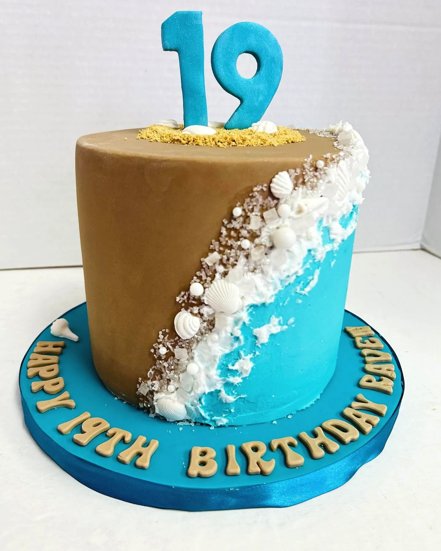 Cute beach themed 19th birthday cake in vibrant colors and fun textures