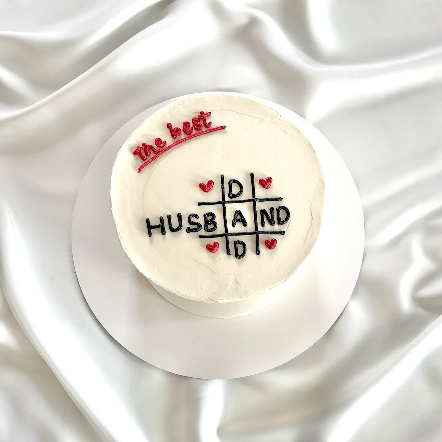Cute birthday cake for men with playful tic-tac-toe design and hearts