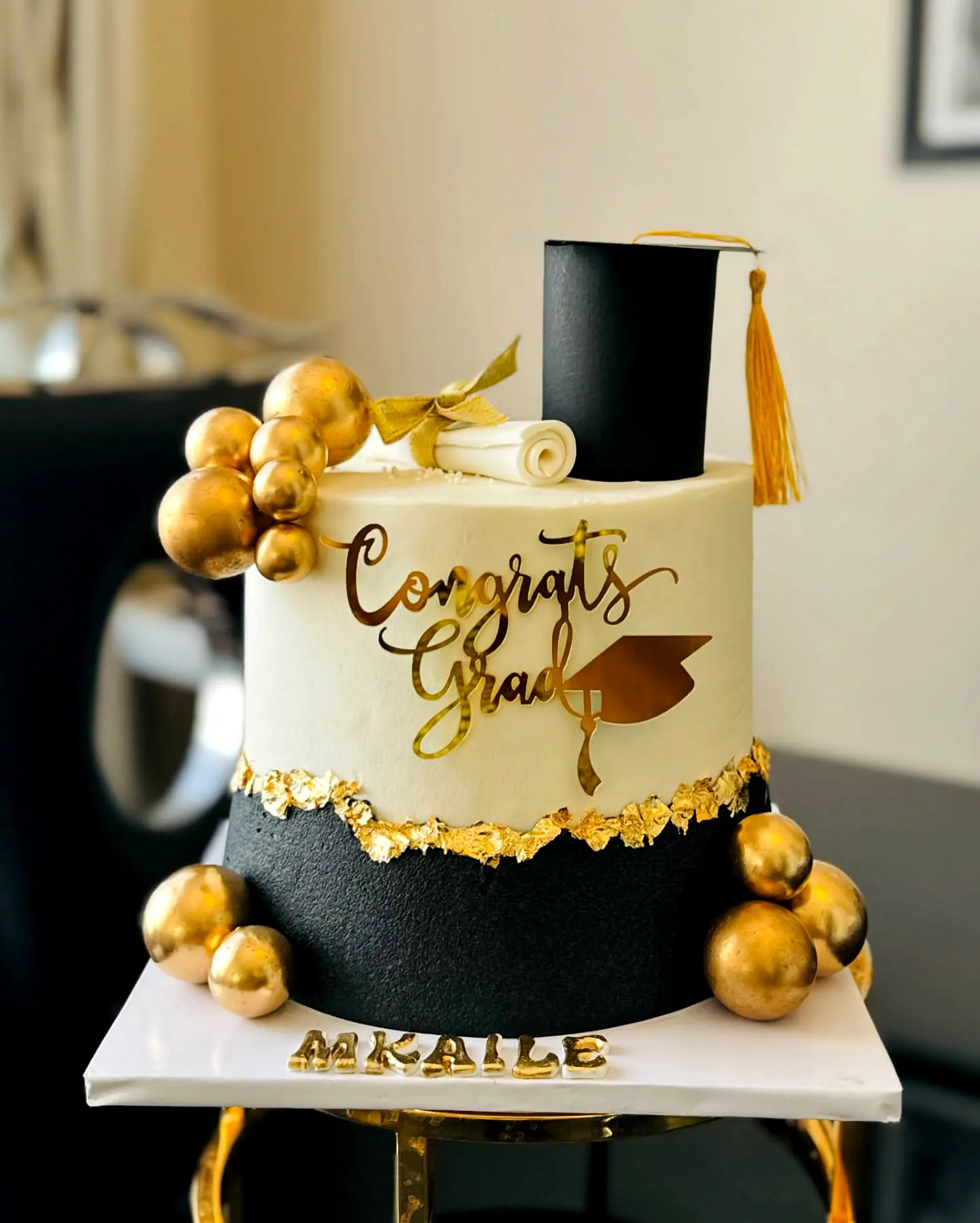 Cute black and gold graduation cake design with stylish decorations and accents