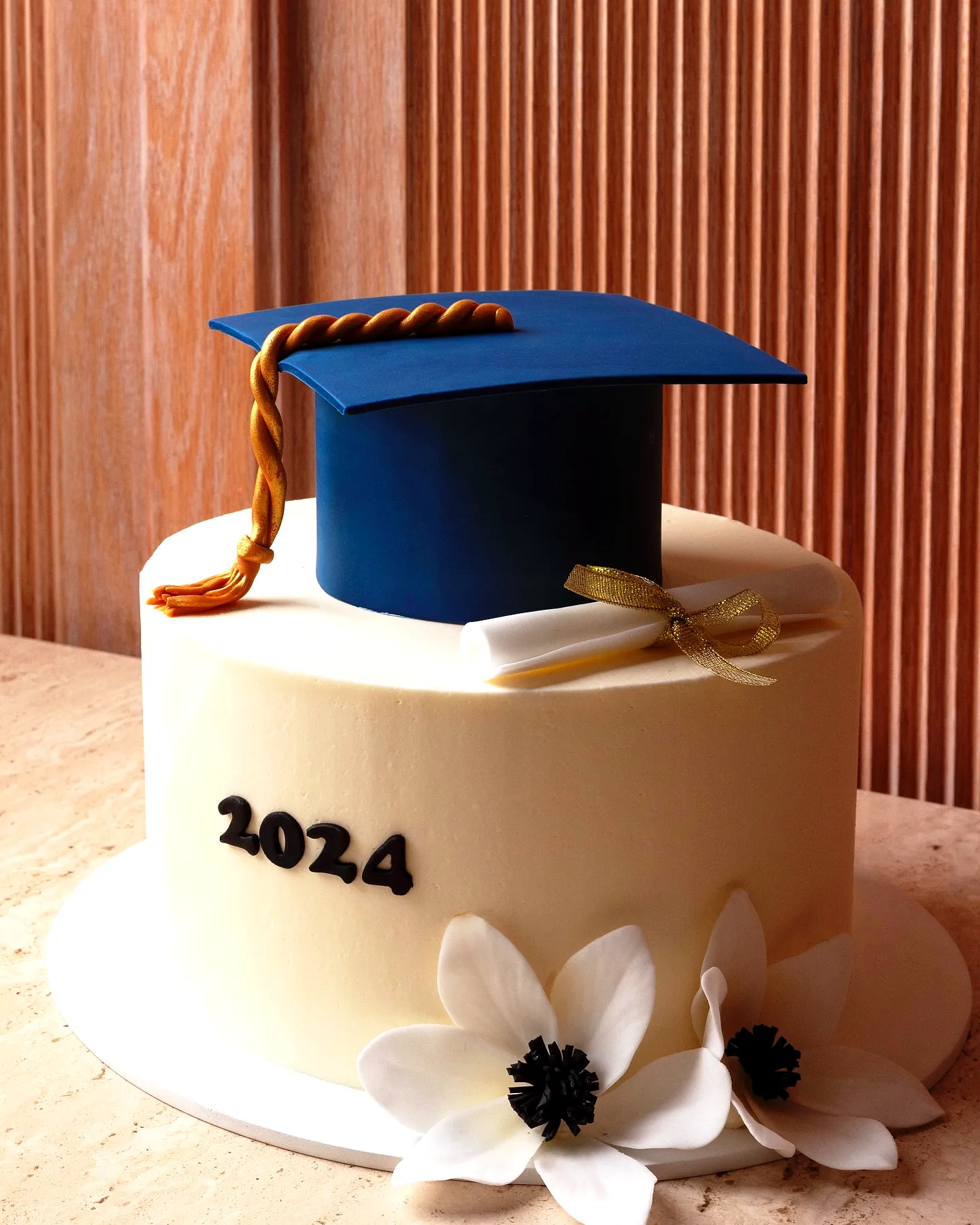 Cute blue and gold graduation cake for a stylish celebration