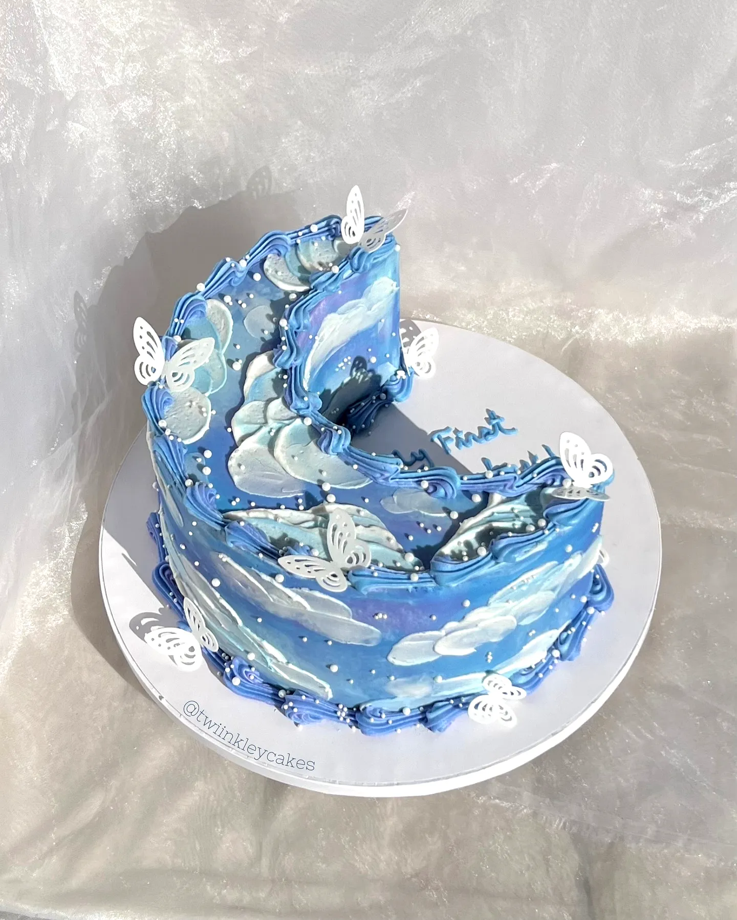Cute Blue Birthday Cake Design with Whimsical Cloud and Butterfly Decorations