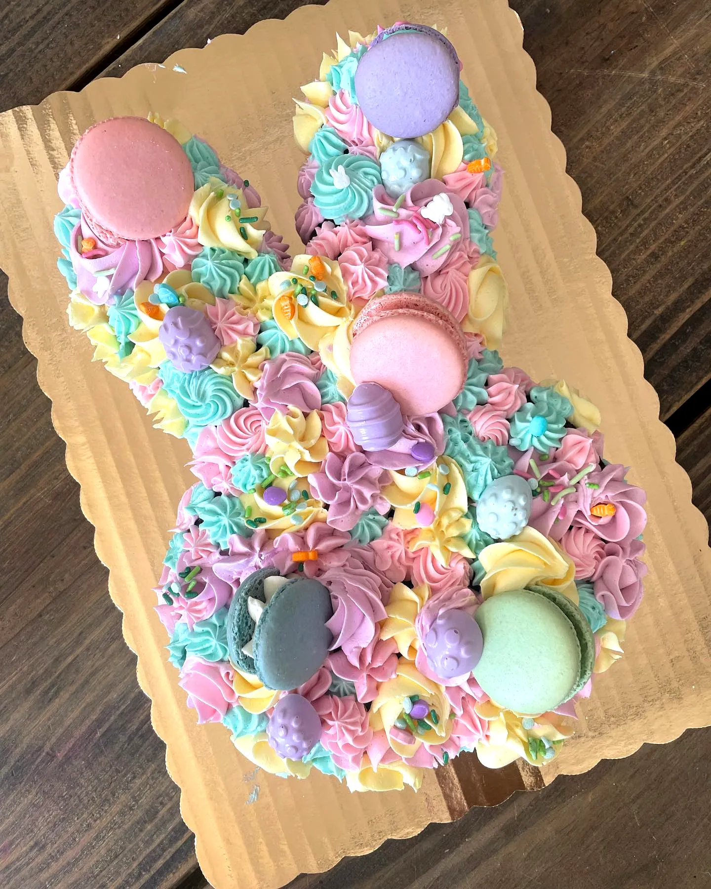 Cute bunny-shaped Easter sheet cake with pastel buttercream frosting