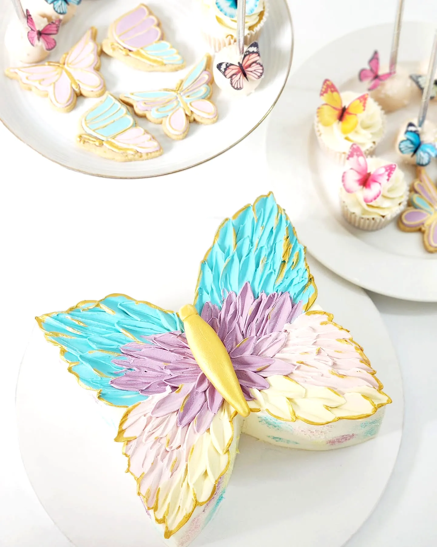 Cute butterfly birthday cake design with vibrant pastel colors and gold details
