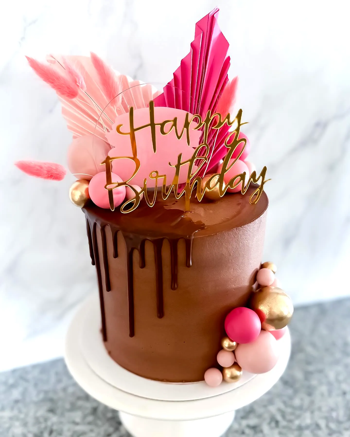 Cute chocolate birthday cake design with vibrant pink and gold decorations