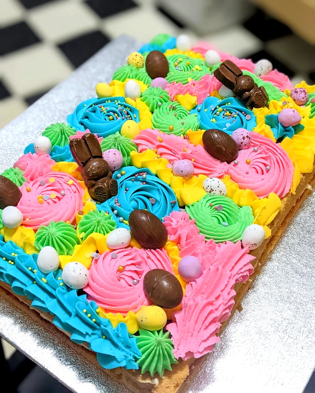 Cute colorful Easter sheet cake design with vibrant buttercream swirls