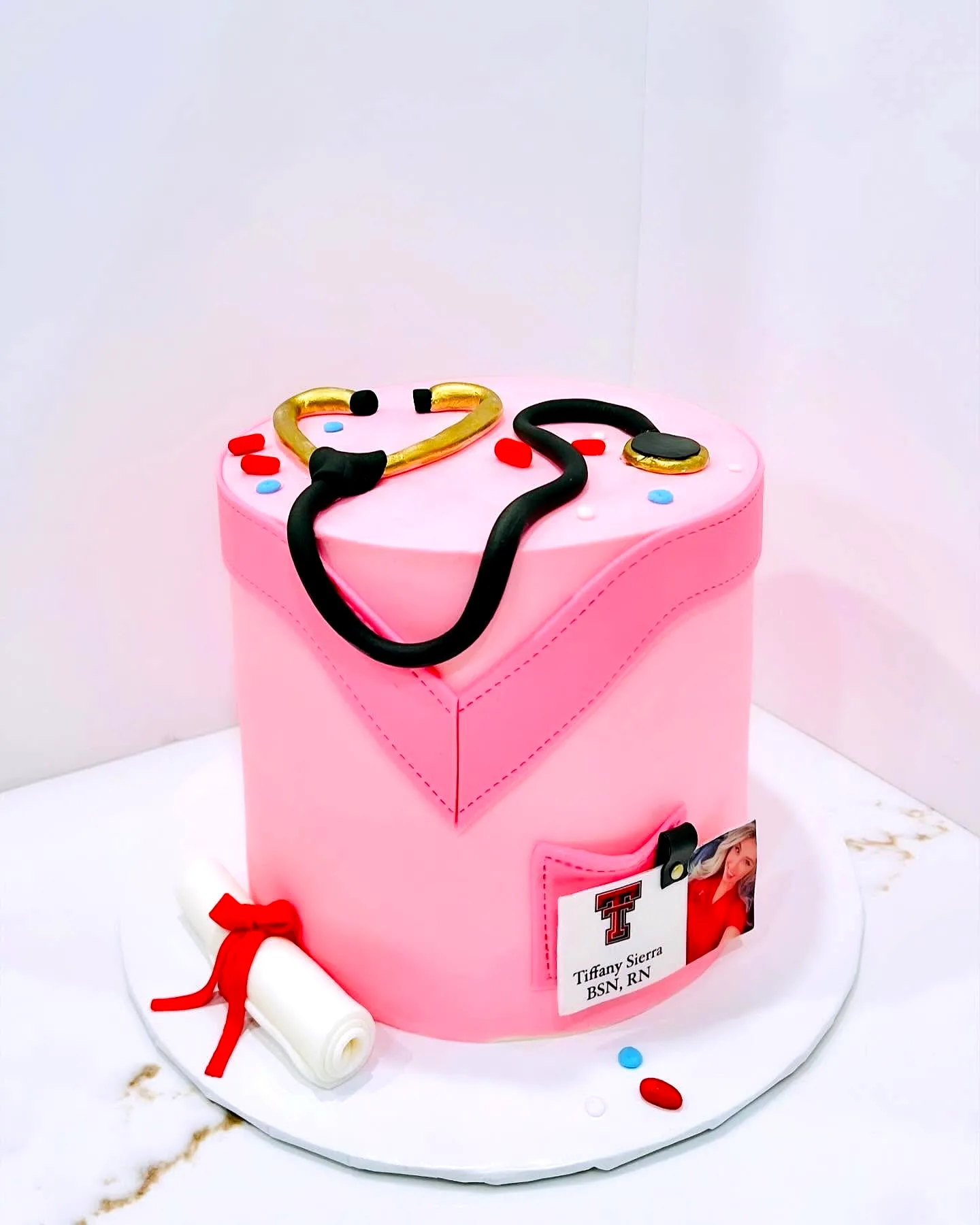 Cute colorful nurse graduation cake design with fondant and fun decorations