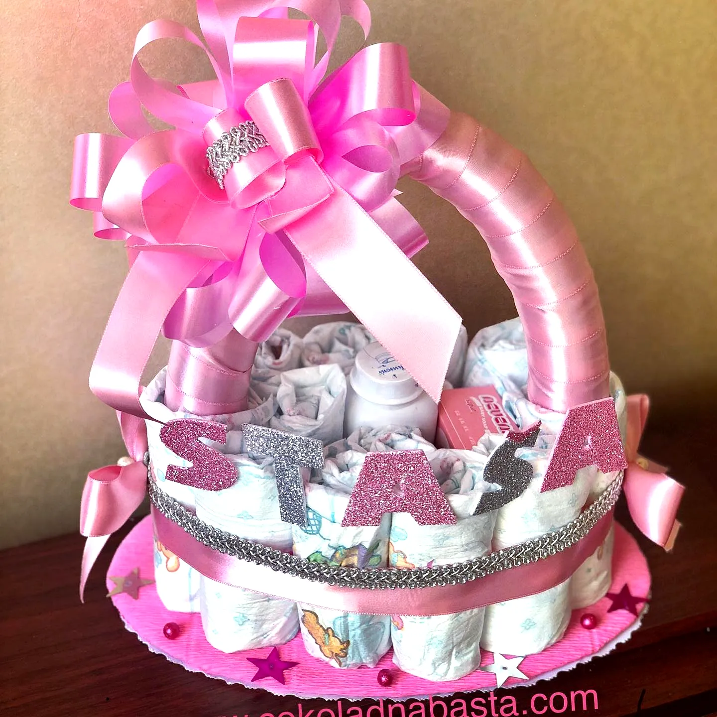 Cute Diaper Cake Design Featuring Pink Colors and Playful Decorations