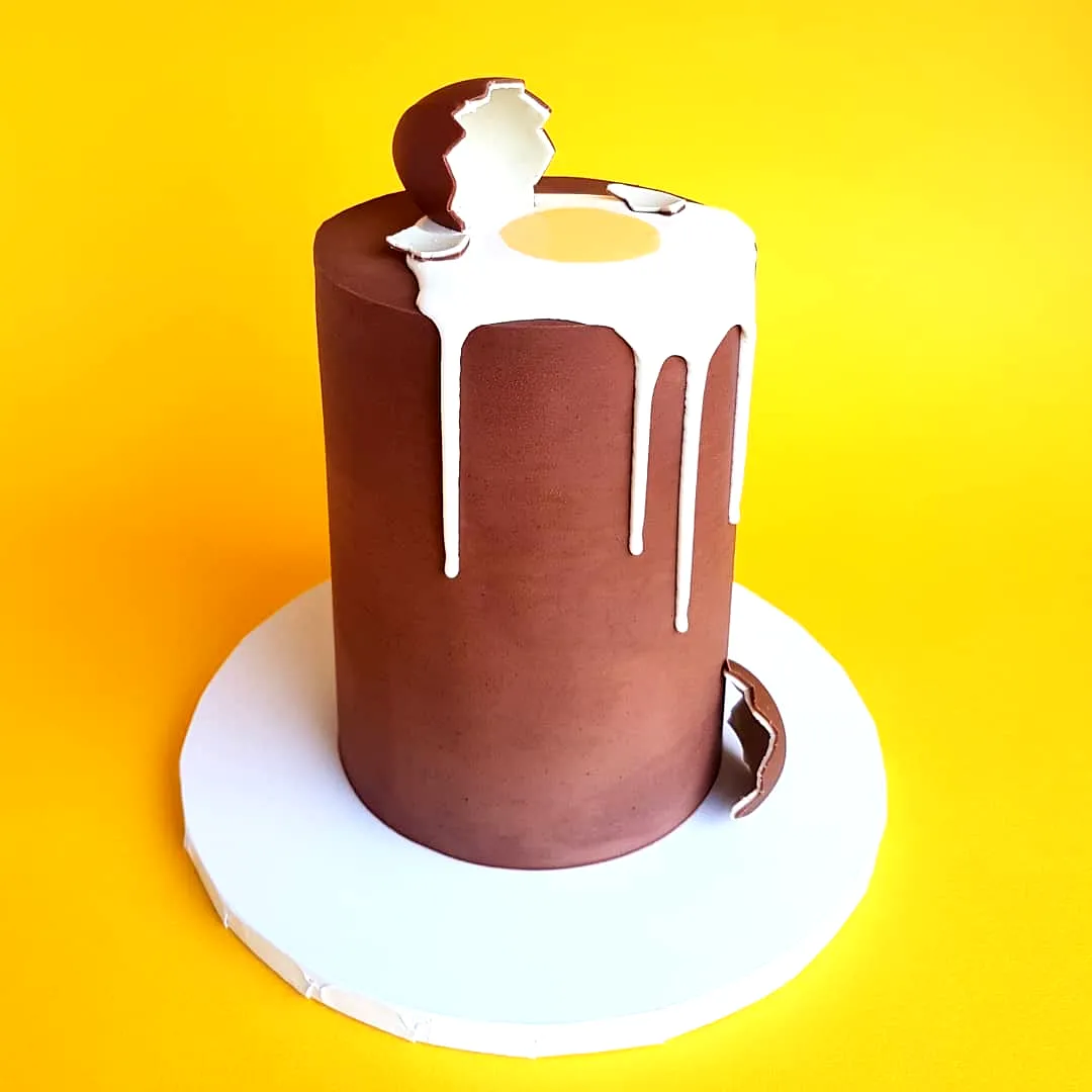 Cute Easter cake design featuring a dripping chocolate egg and vibrant accents