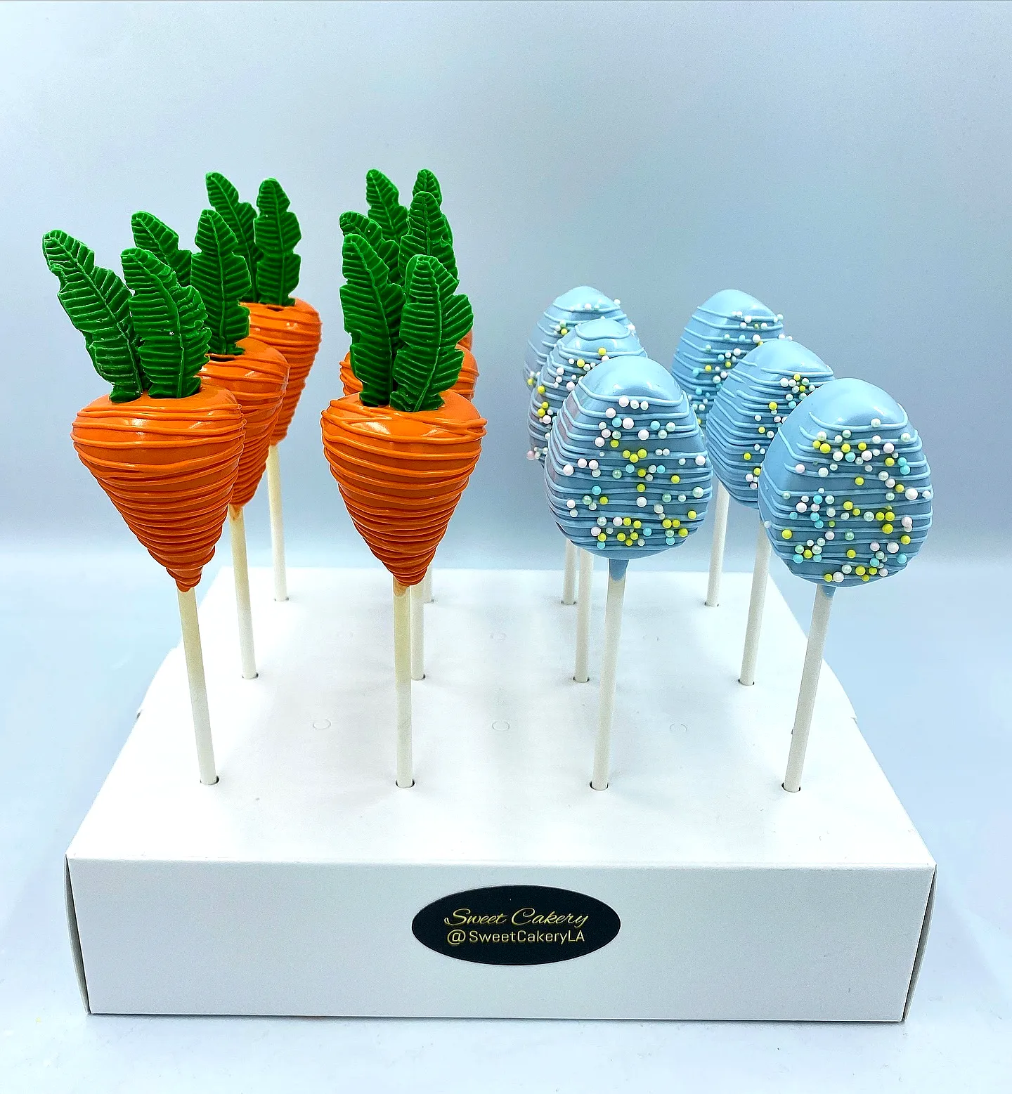 Cute Easter cake pop design featuring vibrant carrots and colorful eggs