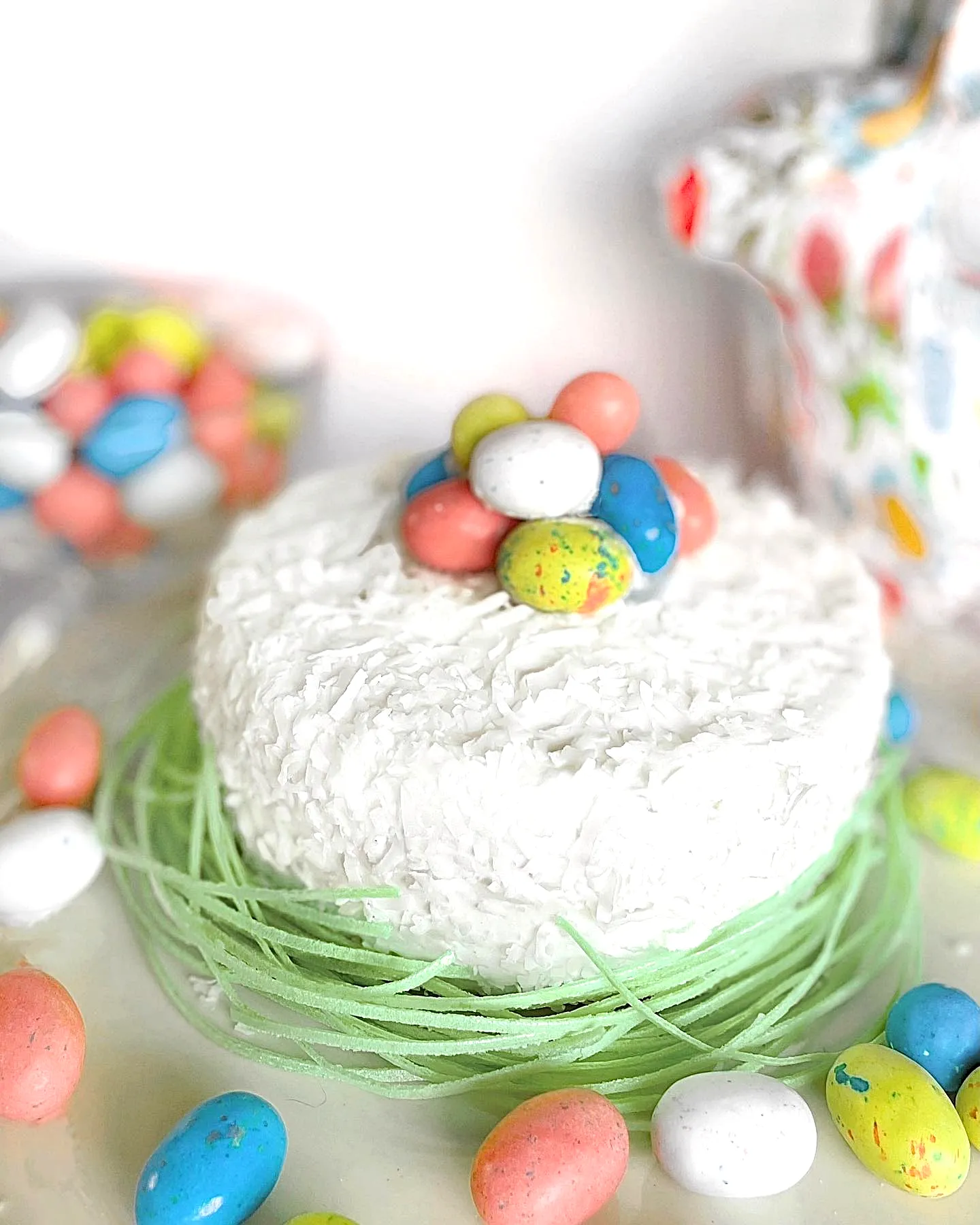 Cute Easter cake with fluffy frosting and colorful candy decorations