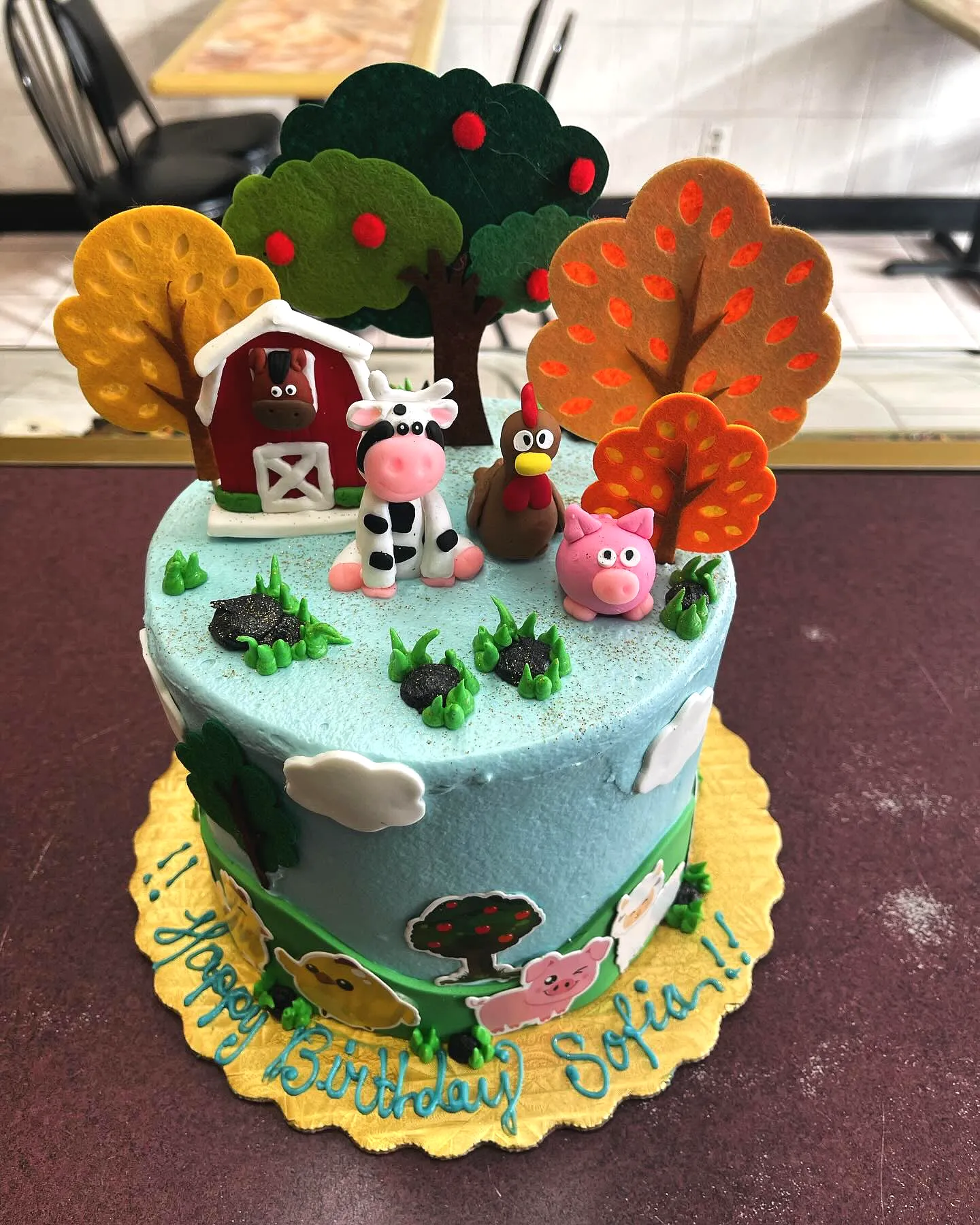 Cute farming birthday cake design with playful decorations and colorful frosting