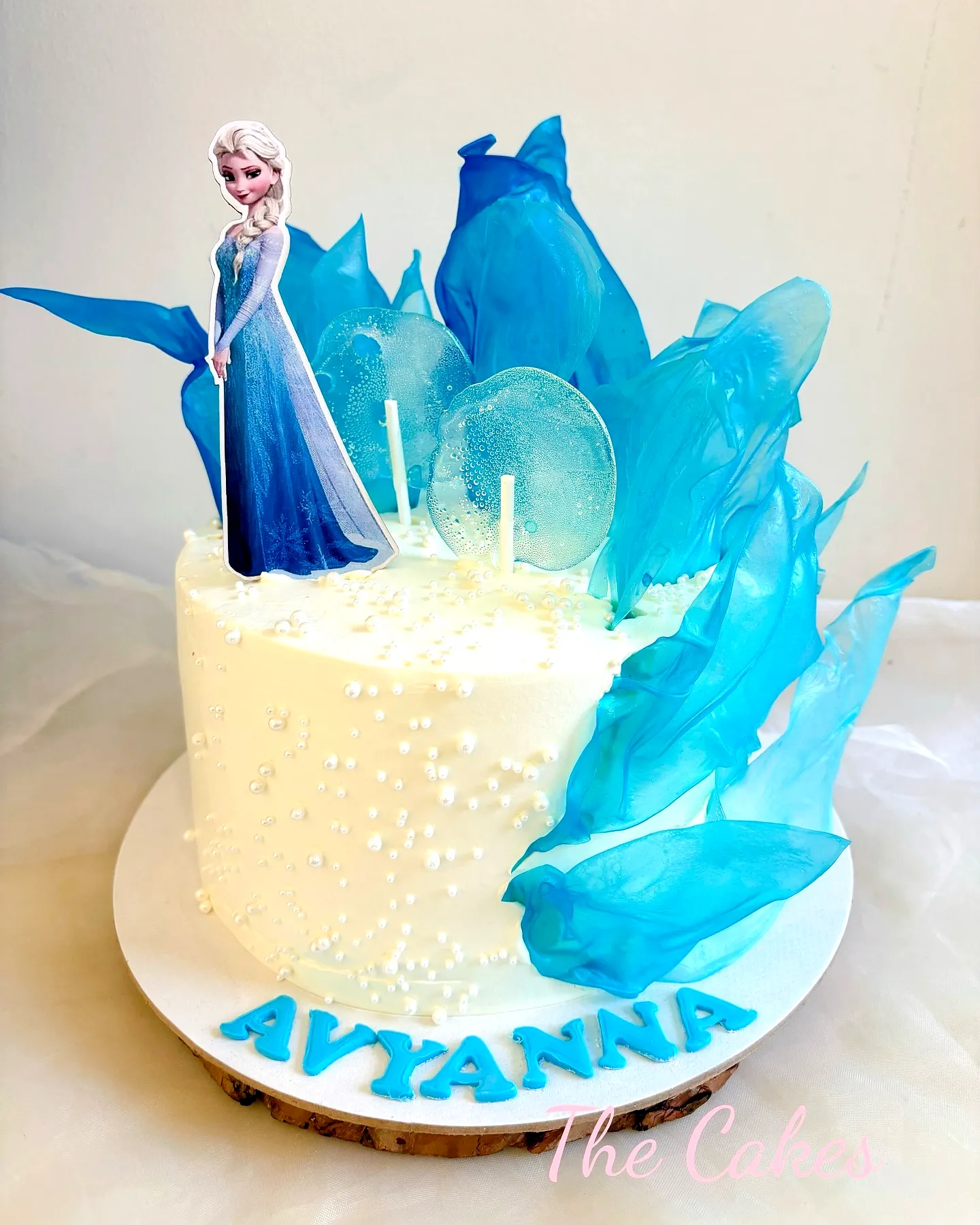 Cute frozen birthday cake design with blue accents and elegant decorations