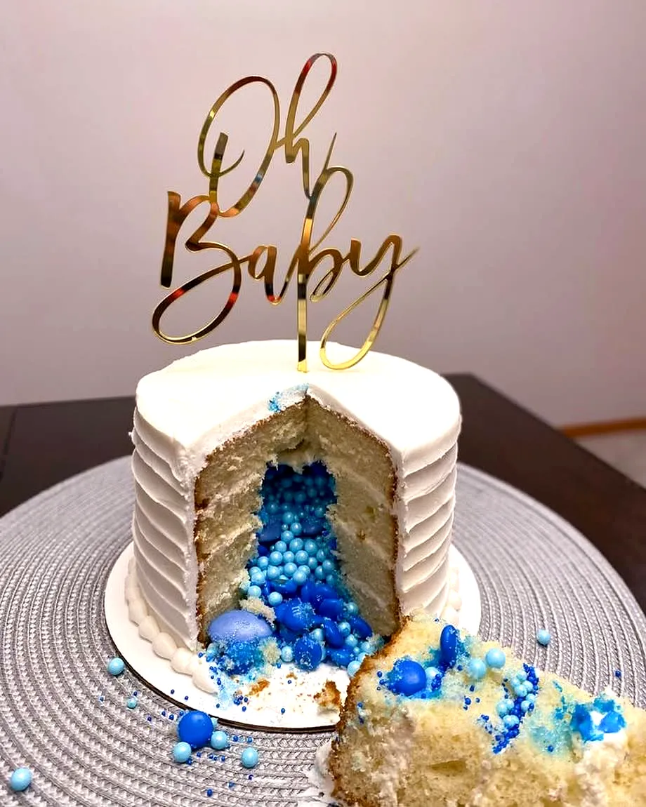 Cute gender reveal cake design with blue filling and elegant decorations