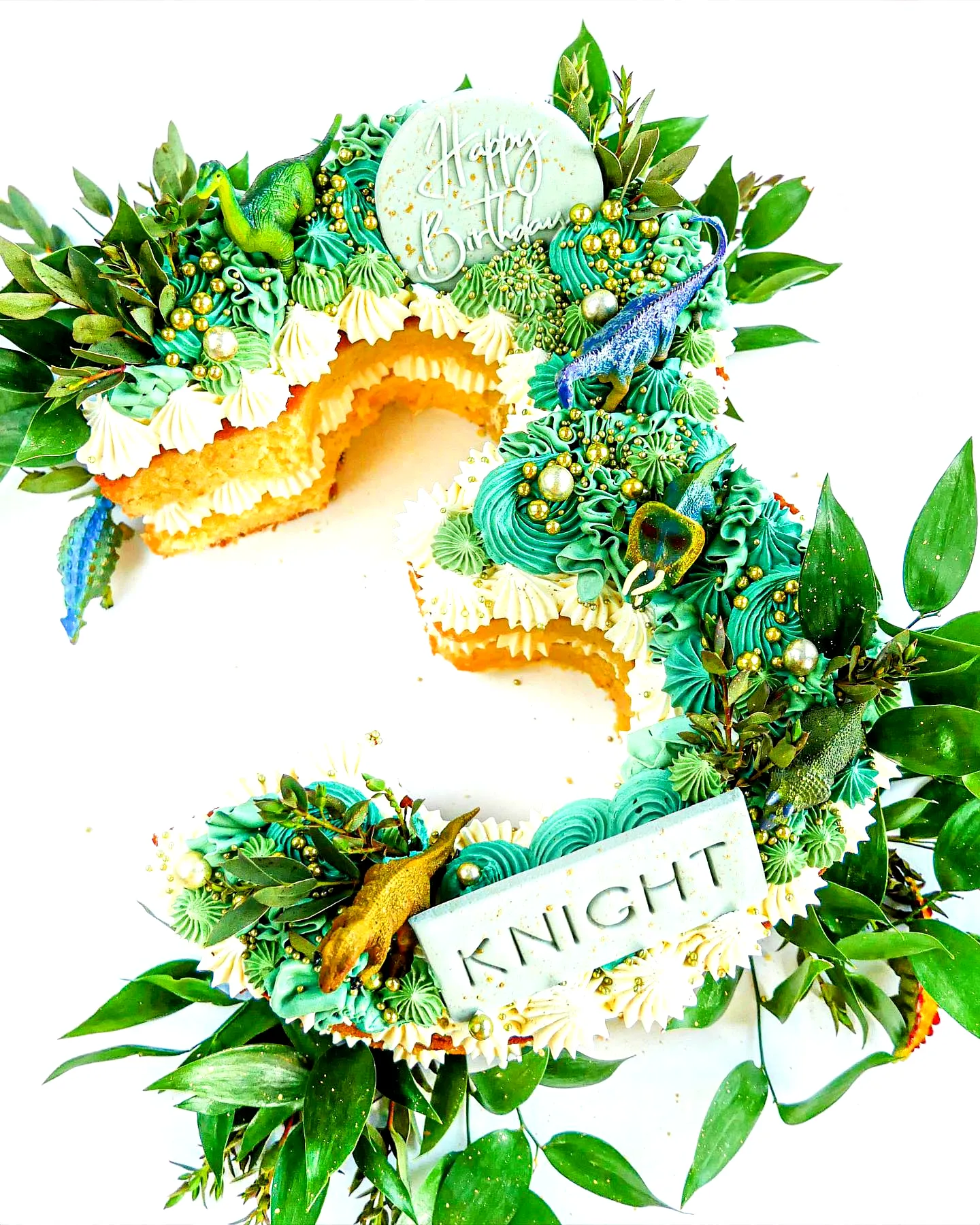 Cute green birthday cake design with playful dinosaur decorations