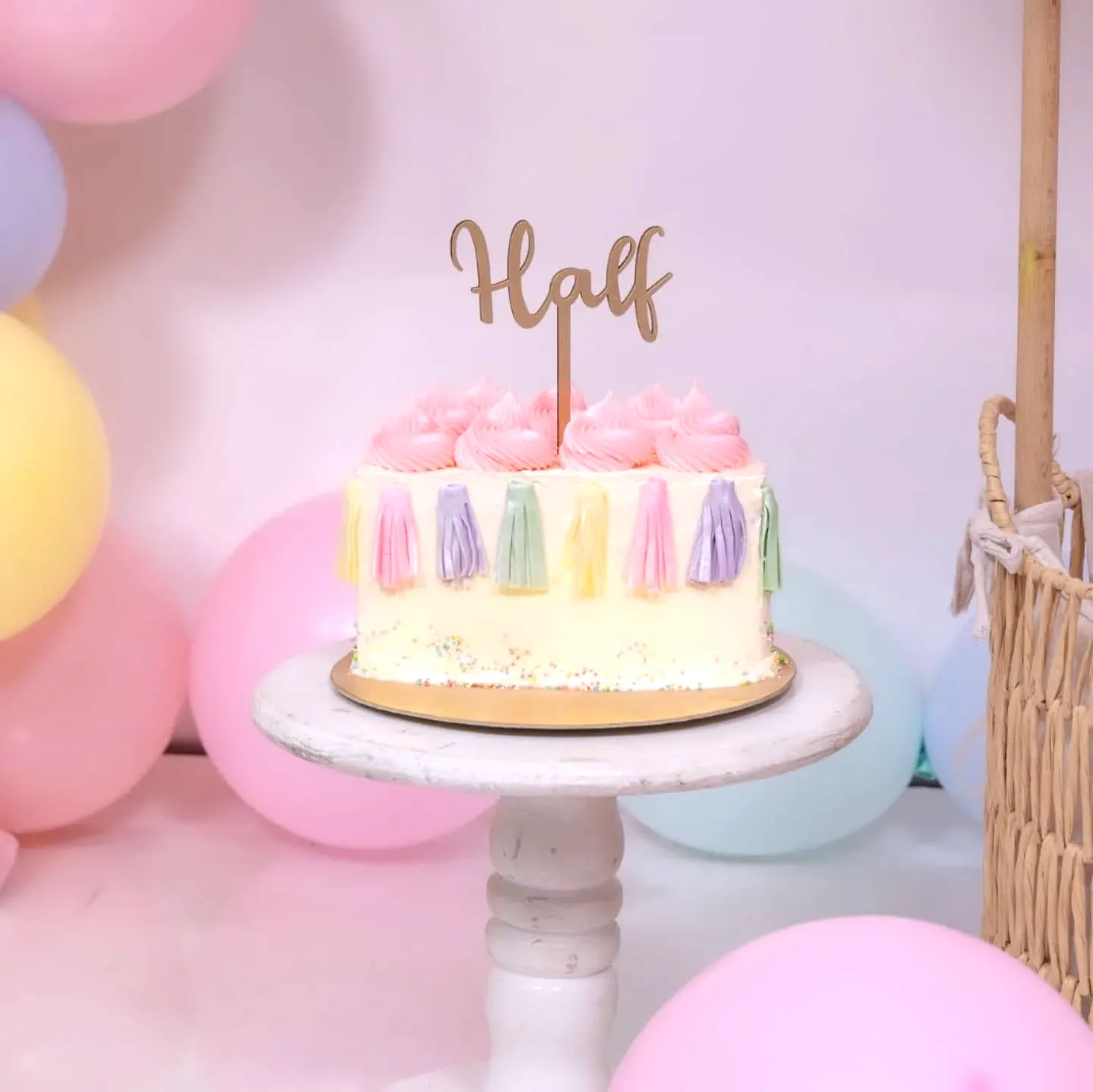 Cute half birthday cake for a trendy celebration with colorful decorations