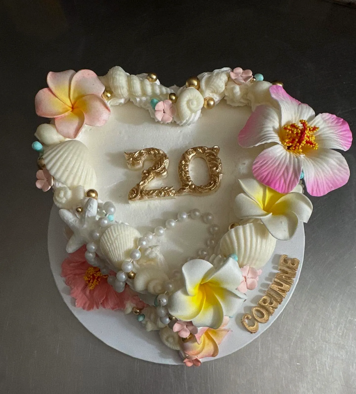 Cute heart-shaped 20th birthday cake with tropical decorations