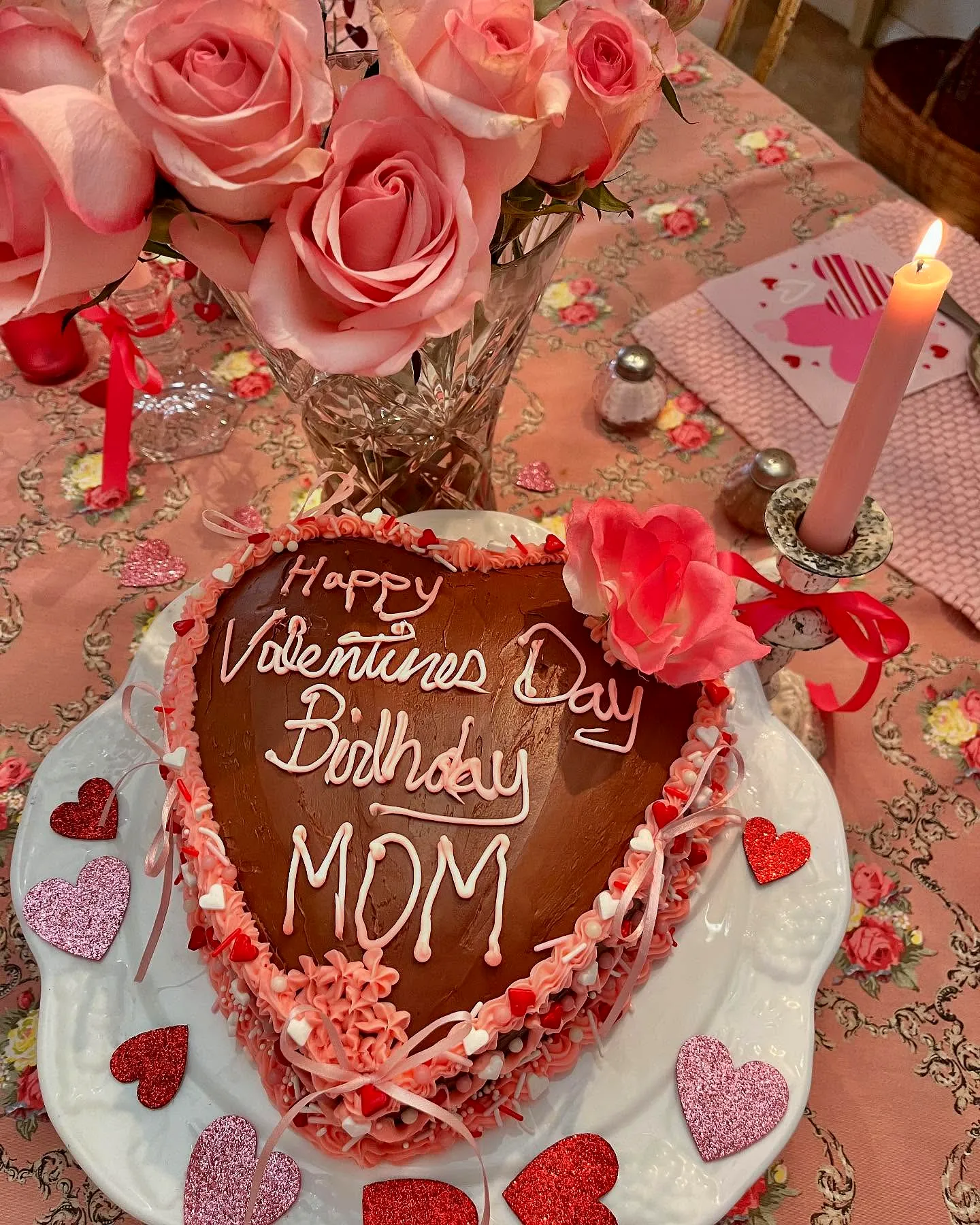Cute heart-shaped chocolate cake for mothers birthday celebration
