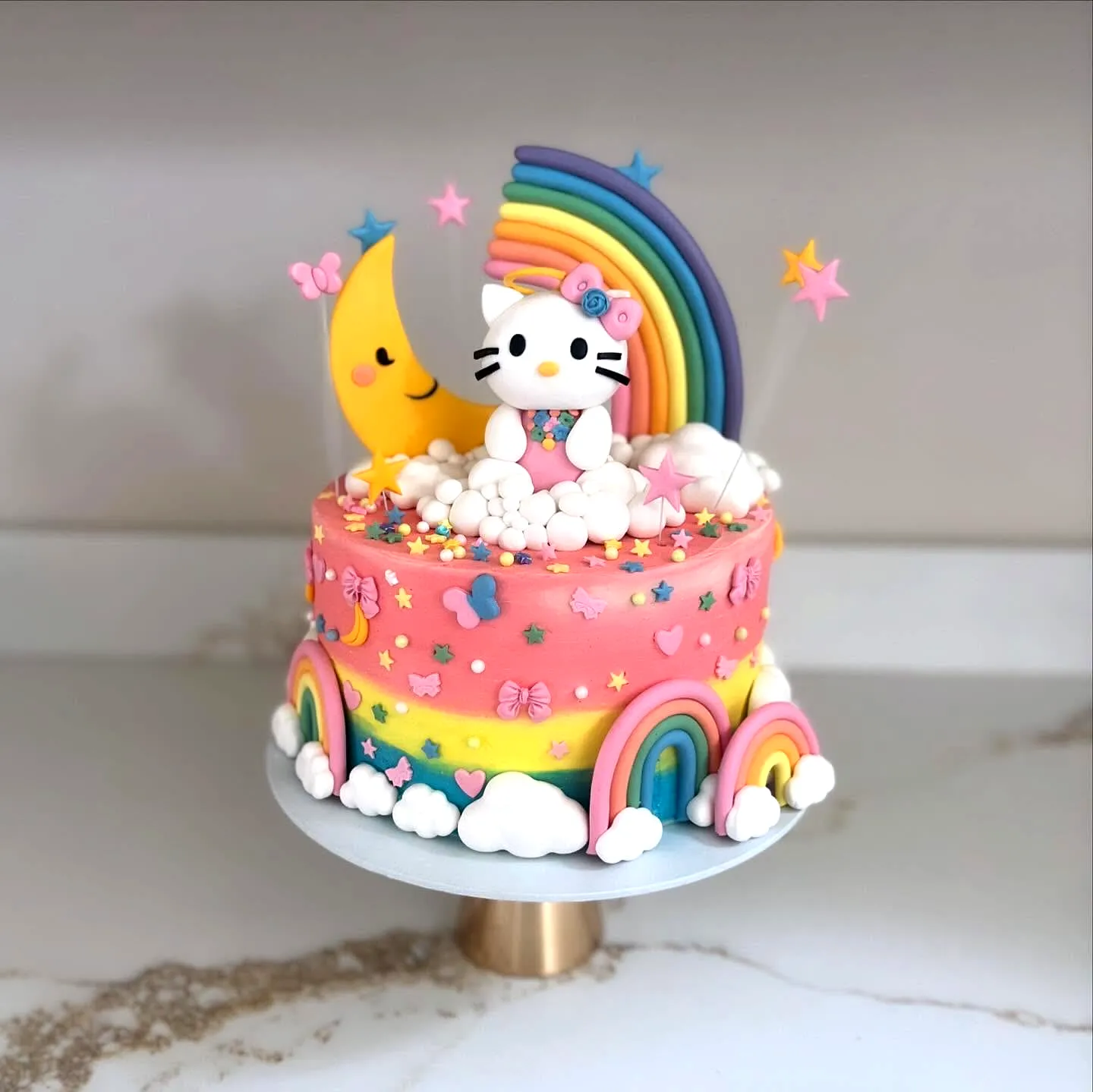 Cute Hello Kitty Cake with Whimsical Buttercream Decorations and Bright Colors