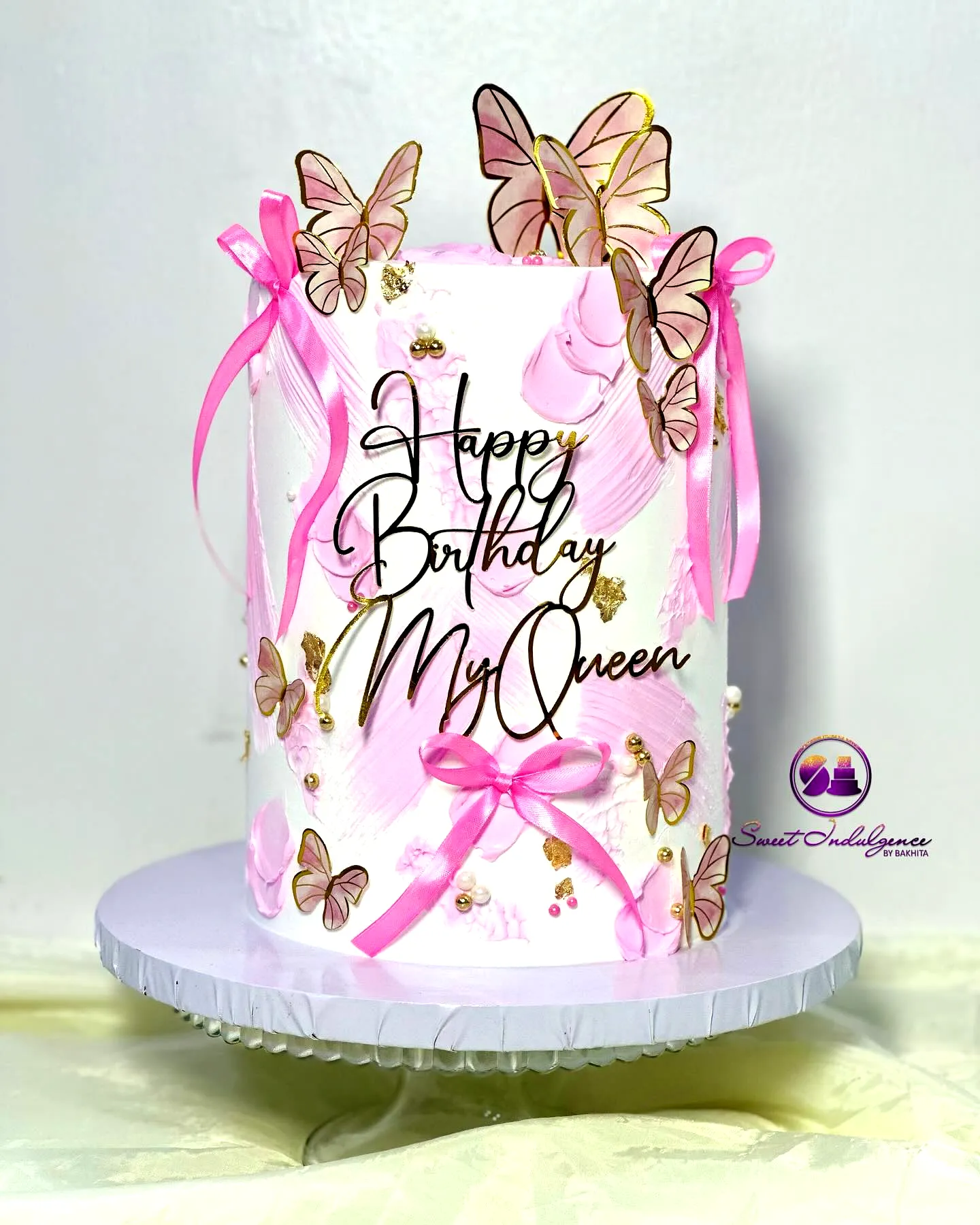 Cute ladies birthday cake design with pink accents and elegant butterflies