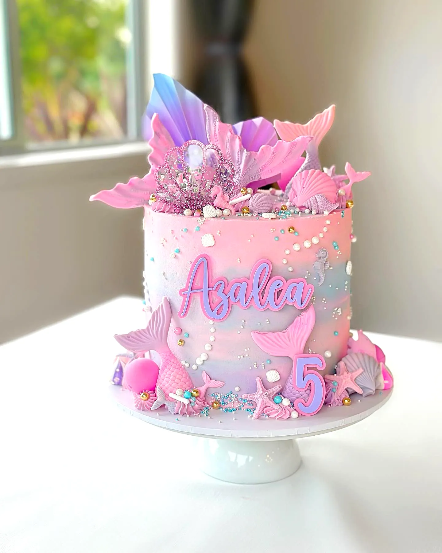 Cute mermaid cake design with pastel ombre and whimsical decorations