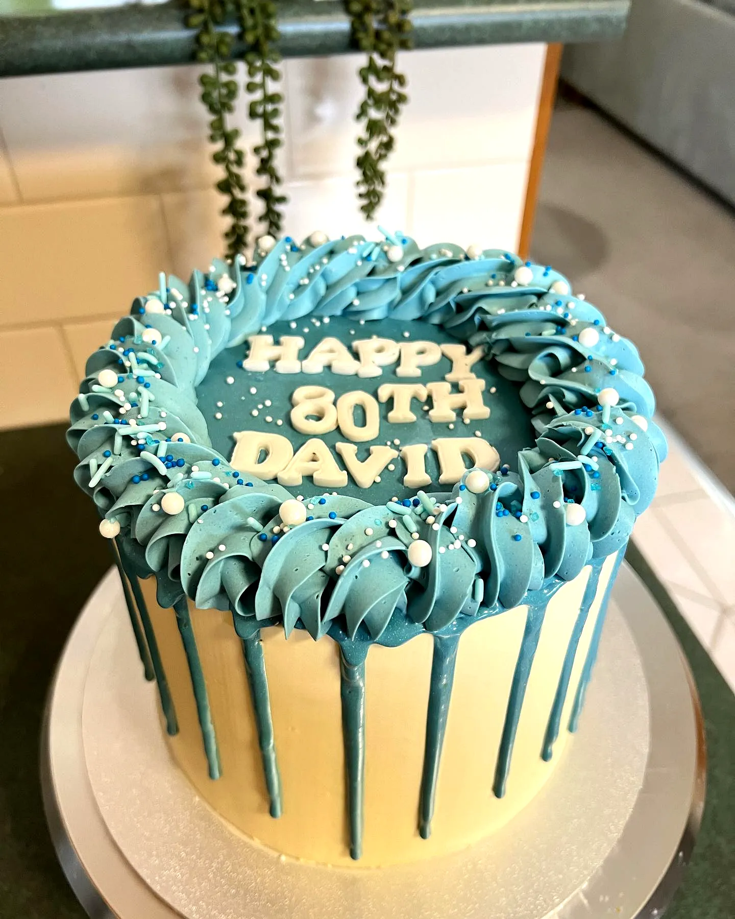 Cute modern 80th birthday cake design with pale yellow and turquoise details
