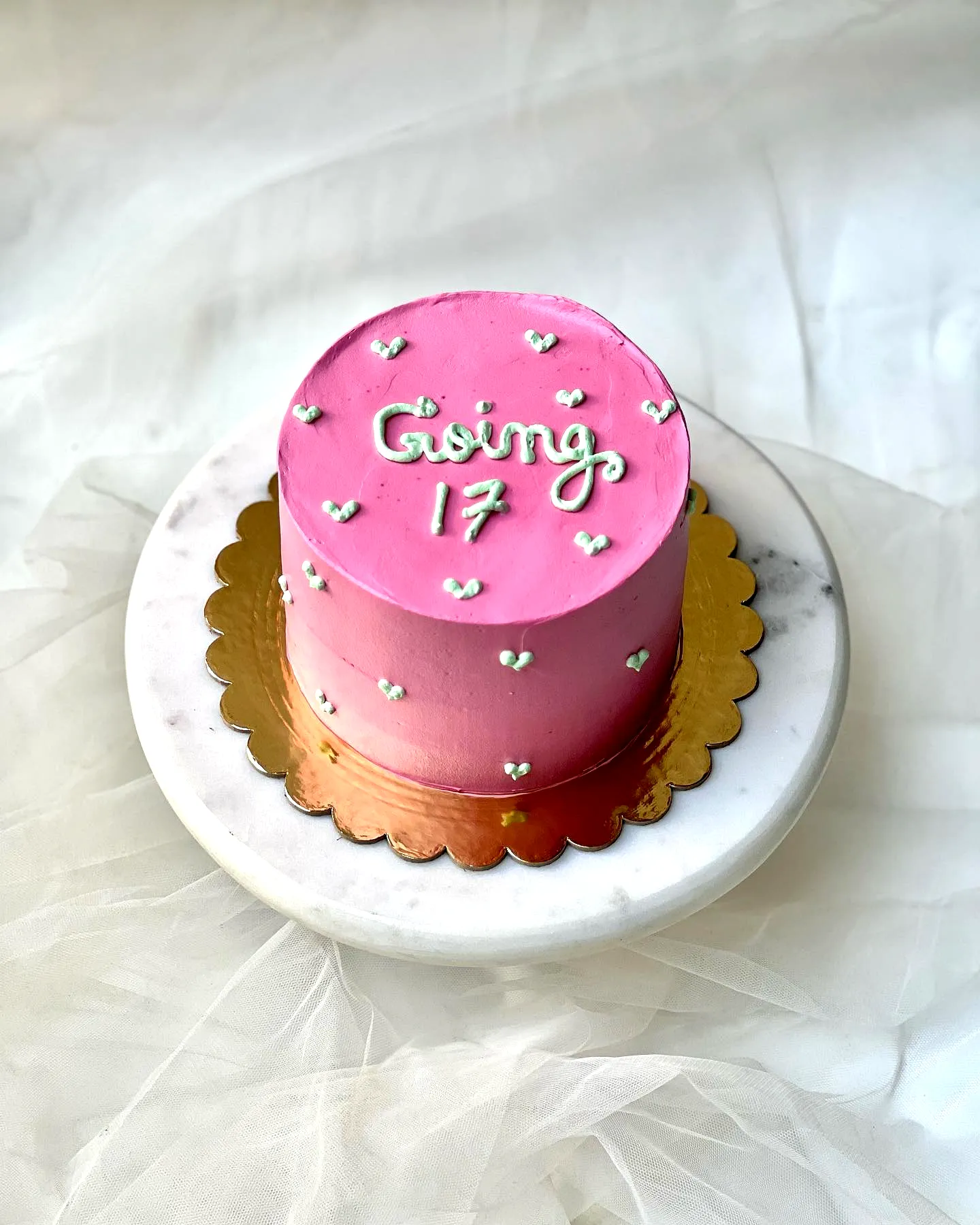 Cute pink buttercream 17th birthday cake design with silver hearts