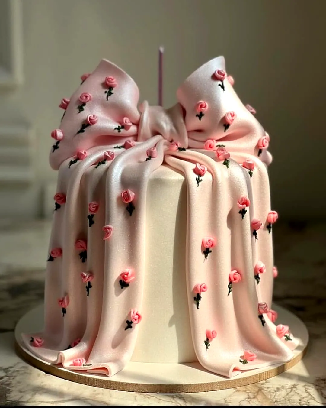 Cute pink fondant birthday cake design for women with elegant floral decorations