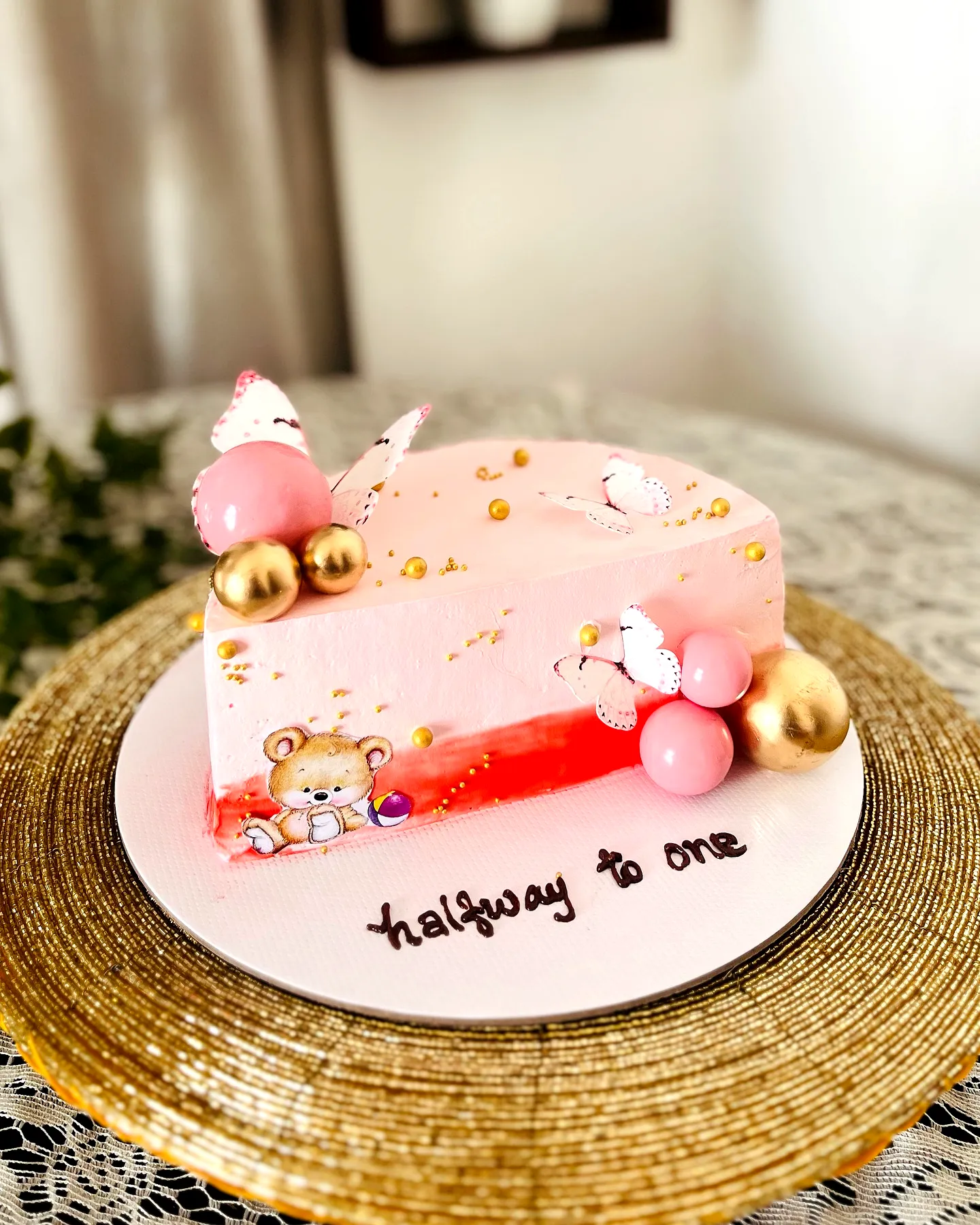 Cute pink half birthday cake for a whimsical celebration