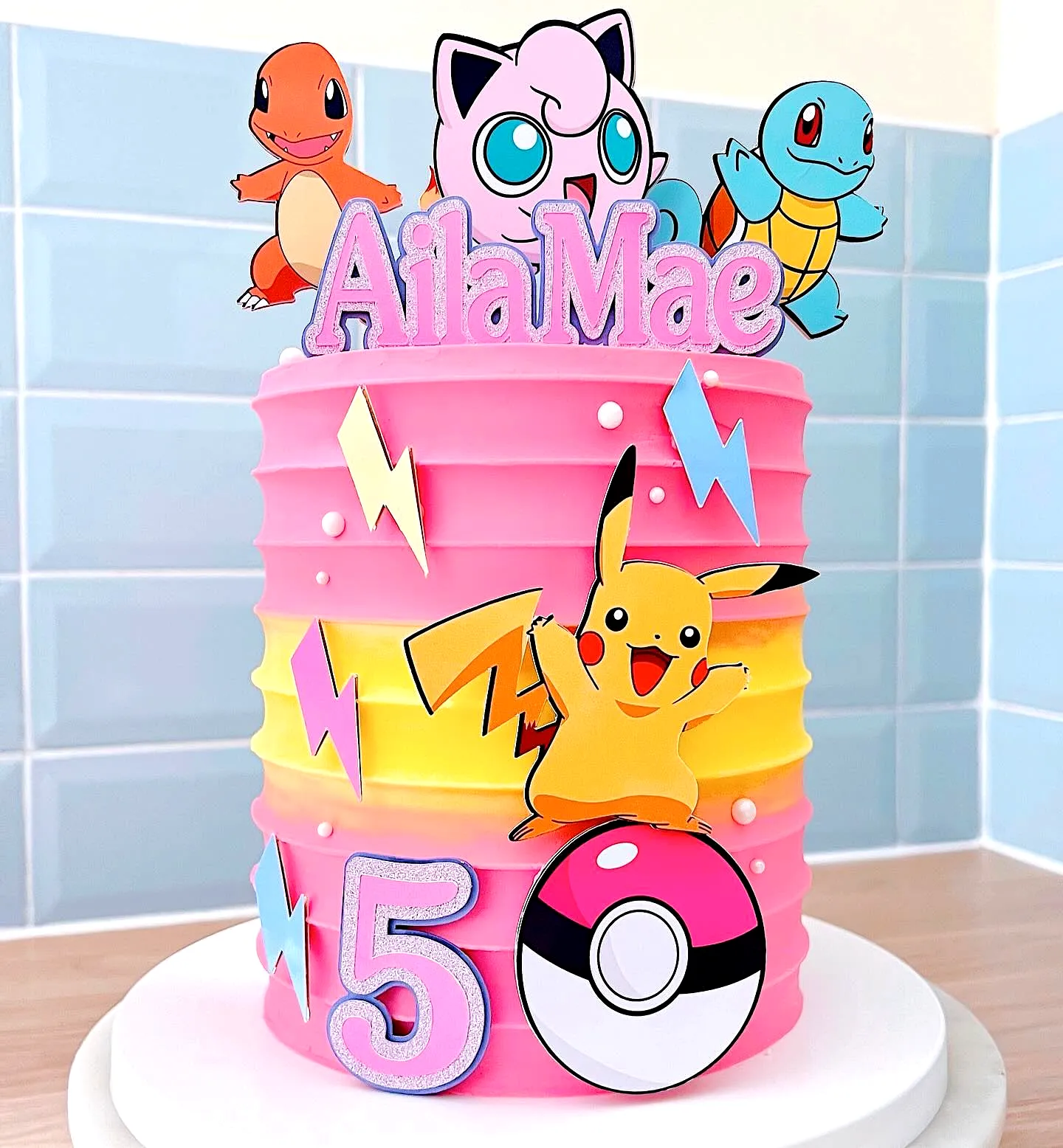 Cute Pokemon Birthday Cake Design with Pink Buttercream and Fun Decorations