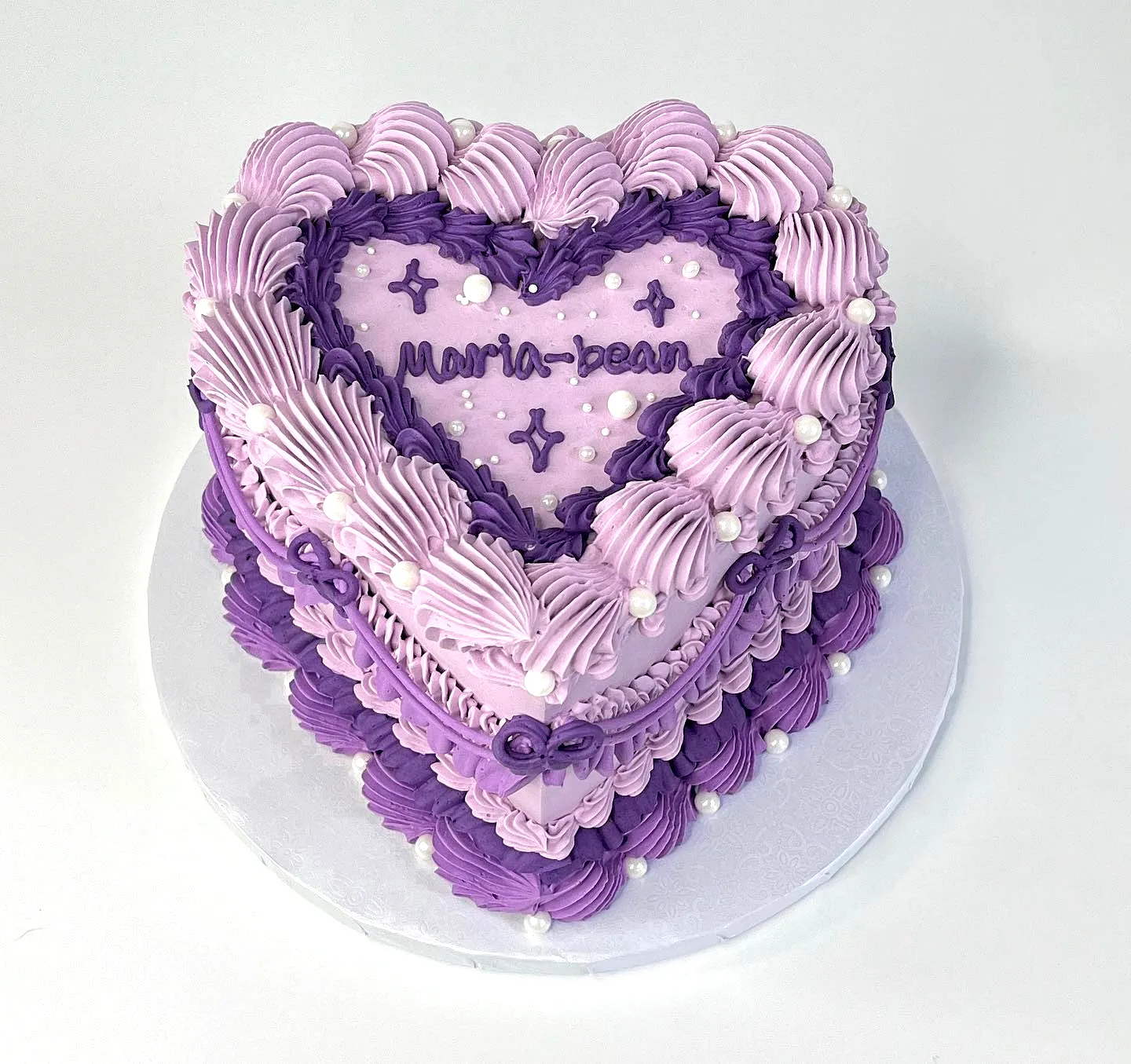 Cute purple birthday cake design with whimsical swirls and personal touches