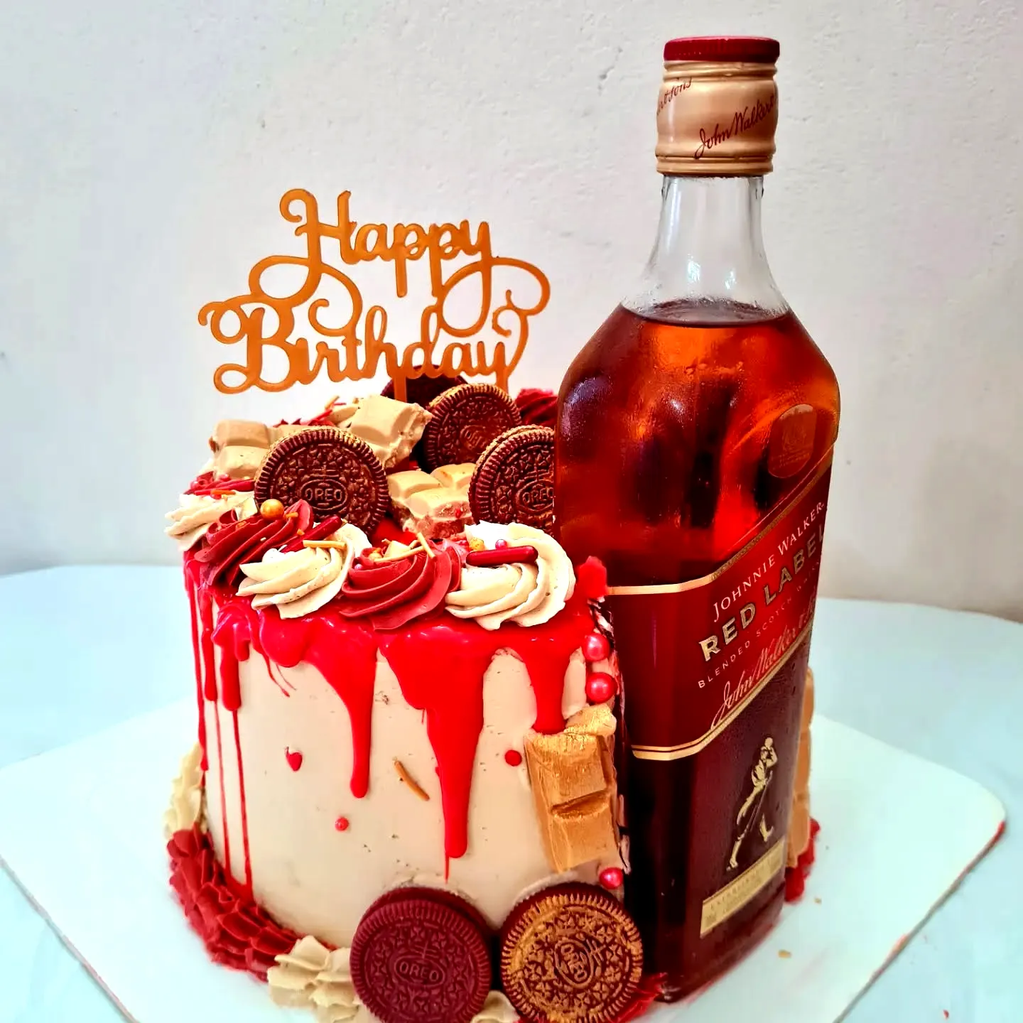 Cute red birthday cake design with drip style and fun festive decorations