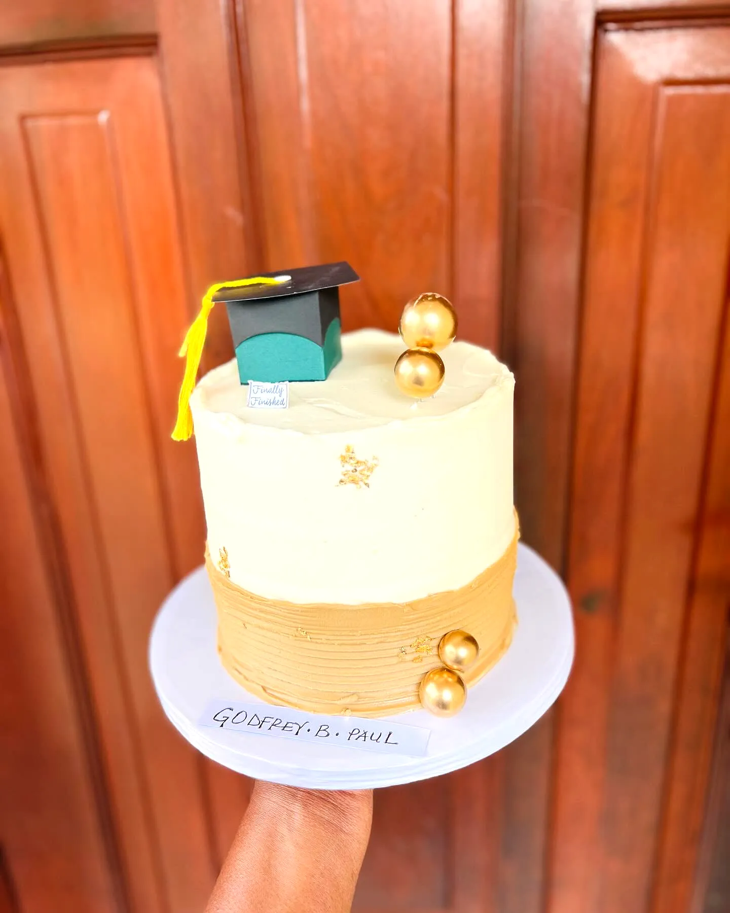 Cute simple graduation cake in elegant off-white and gold design