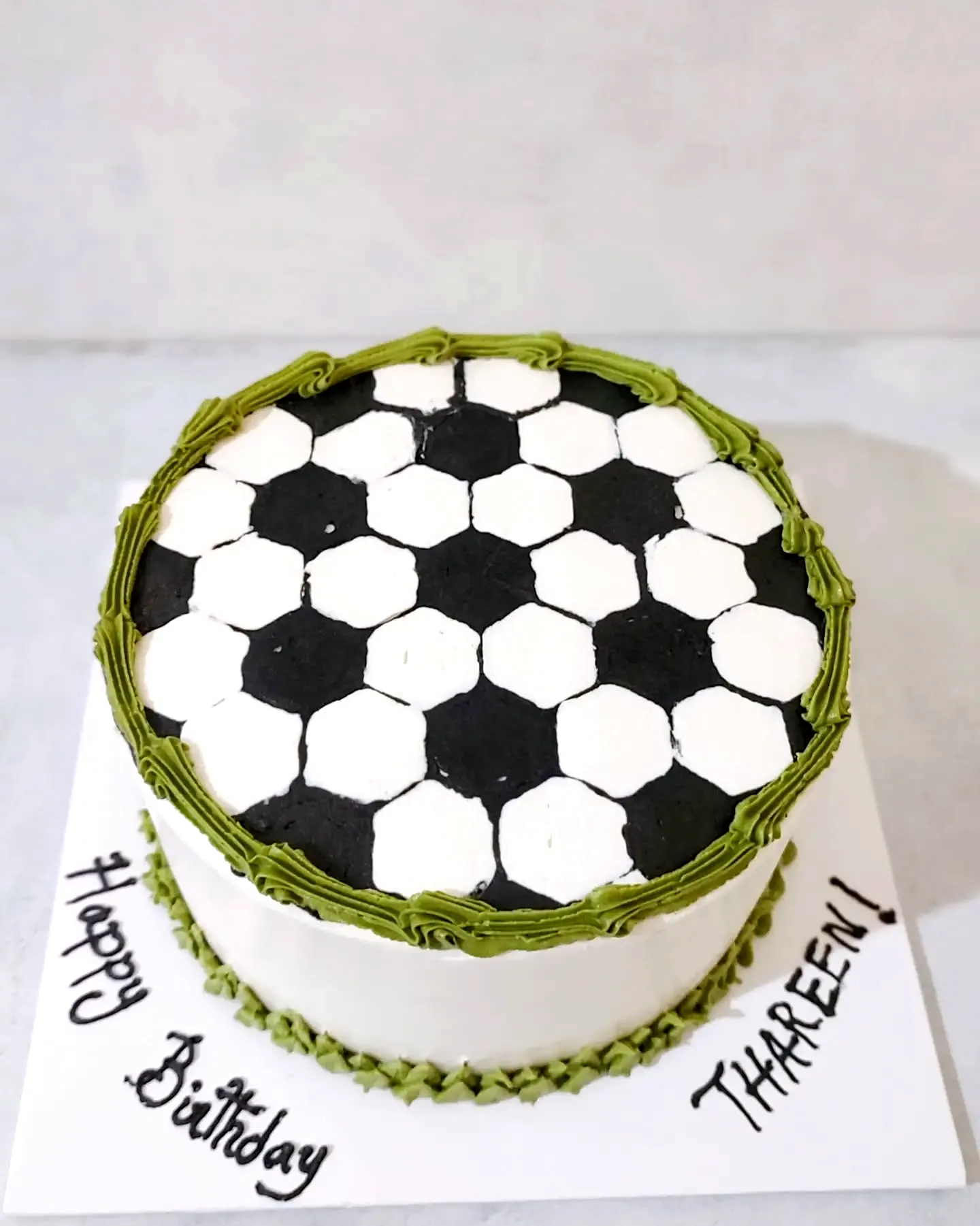 Cute soccer birthday cake design with black and white patterns