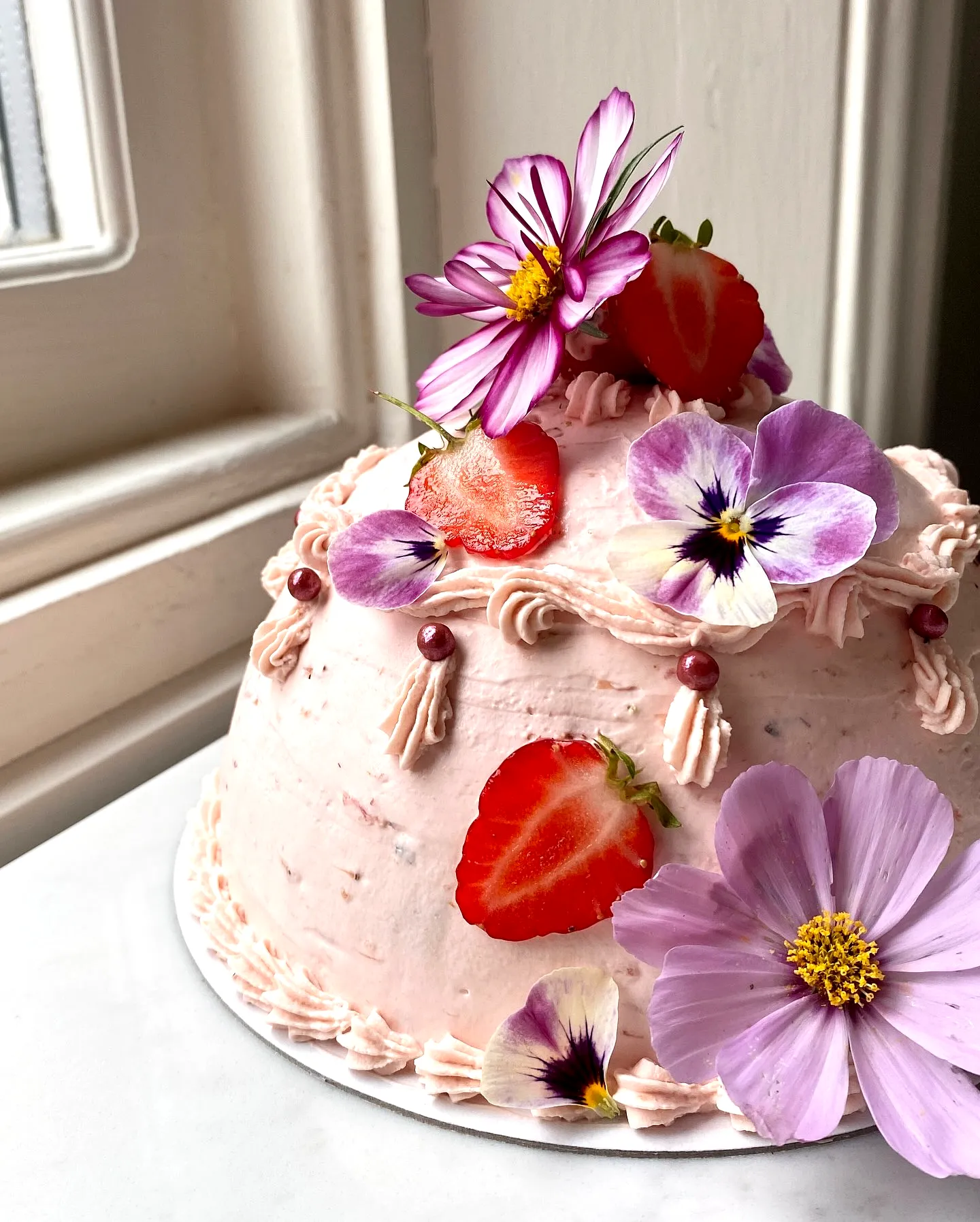 Cute strawberry birthday cake design with floral touches and whimsical charm