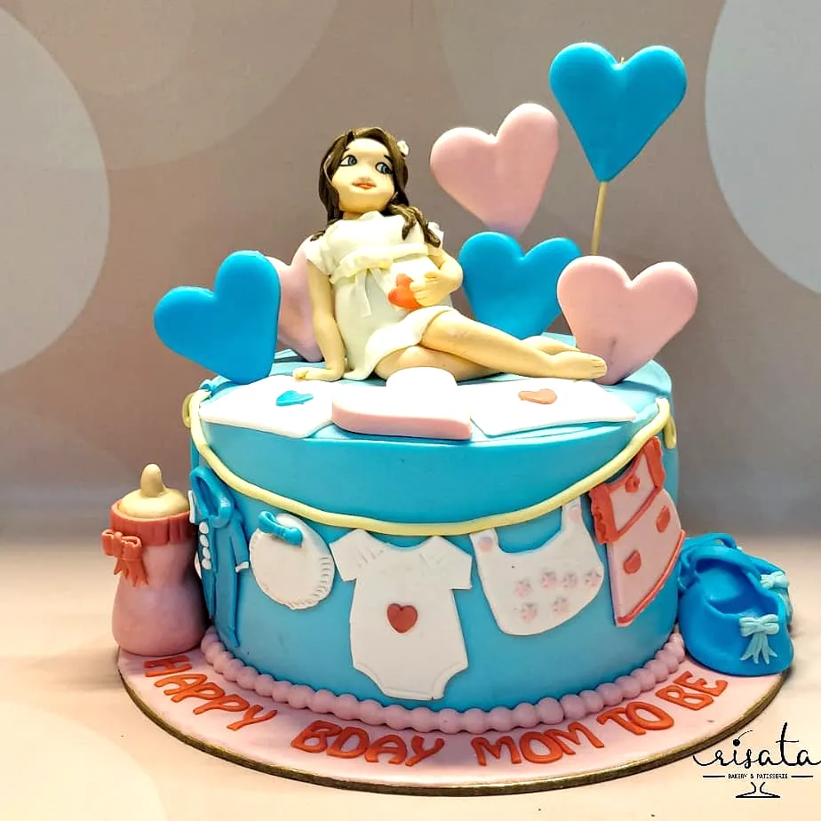 Cute two-tiered baby shower cake with playful decorations and colors