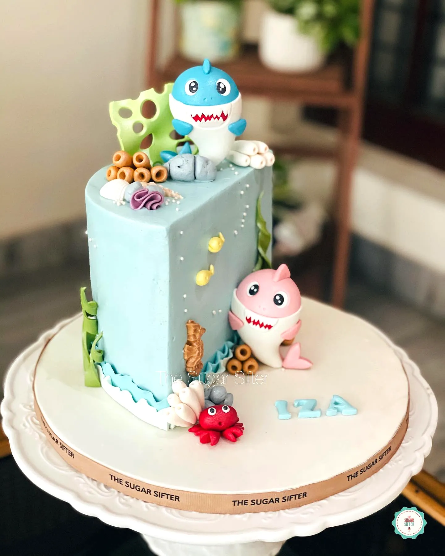 Cute underwater half birthday cake design with playful shark decorations