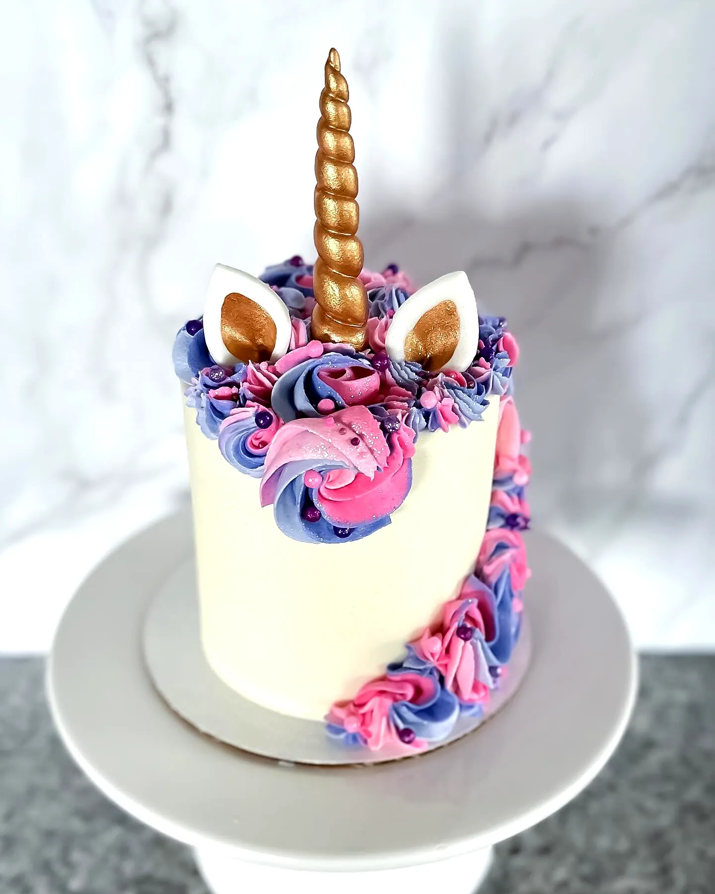 Cute unicorn birthday cake design in soft pastel colors and whimsical textures