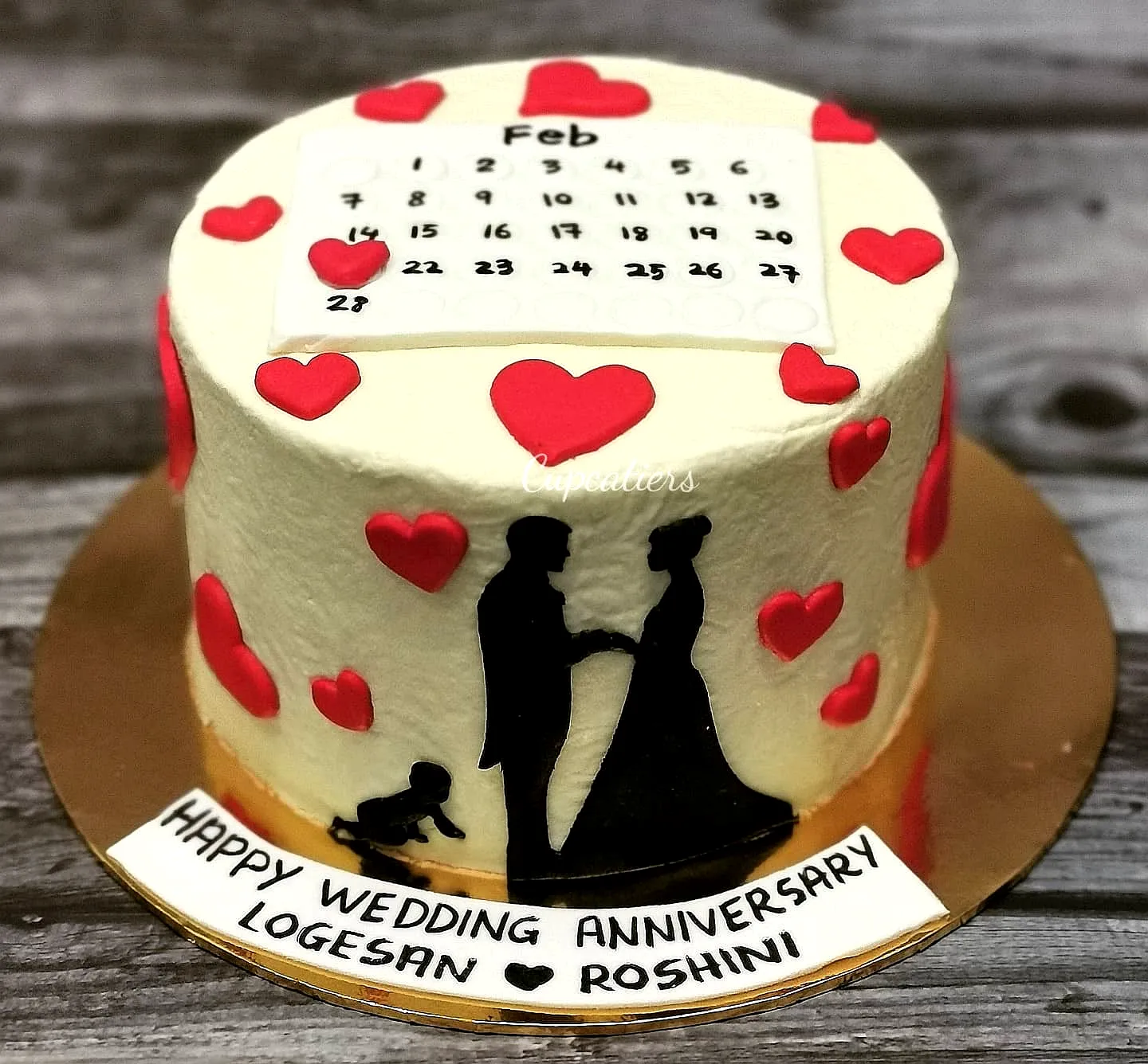 Cute wedding anniversary cake with romantic decorations and festive colors