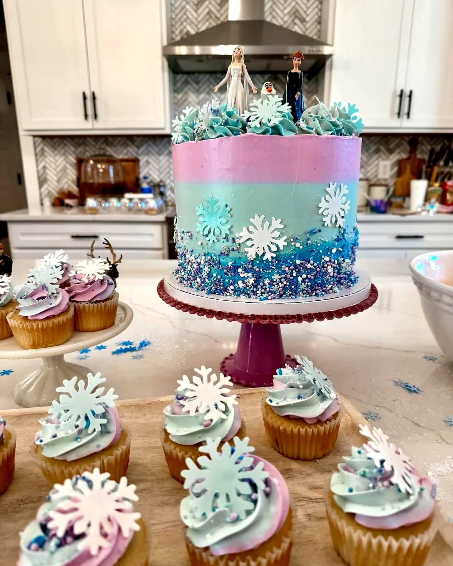 Cute winter themed frozen birthday cake with ombre frosting and glitter decorations