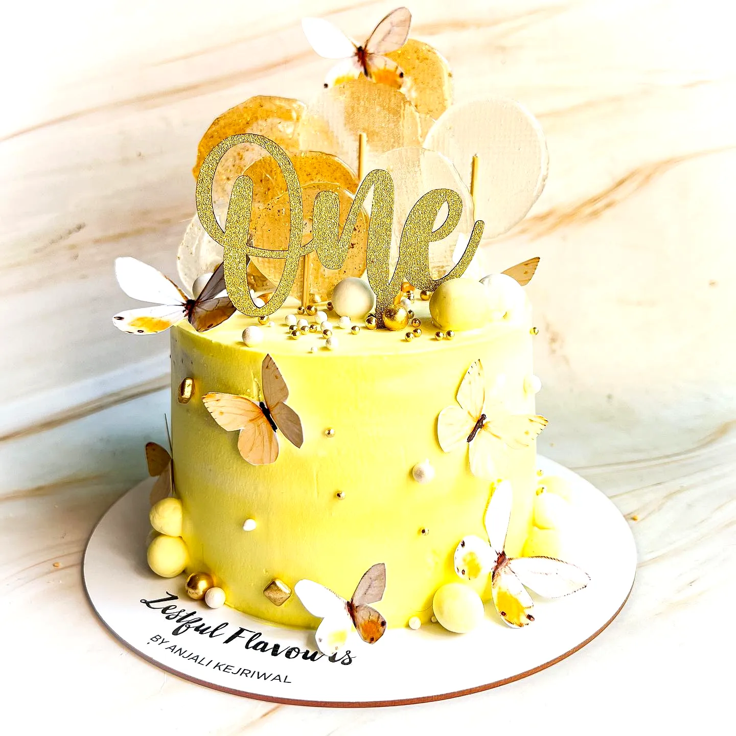 Cute yellow birthday cake design for a whimsical first birthday celebration