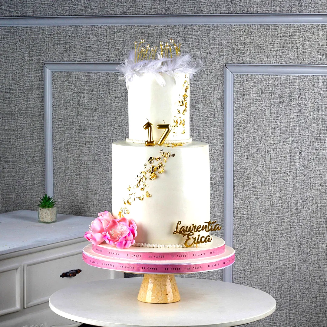 Elegant 17th Birthday Cake Design with Gold Accents and Floral Touches