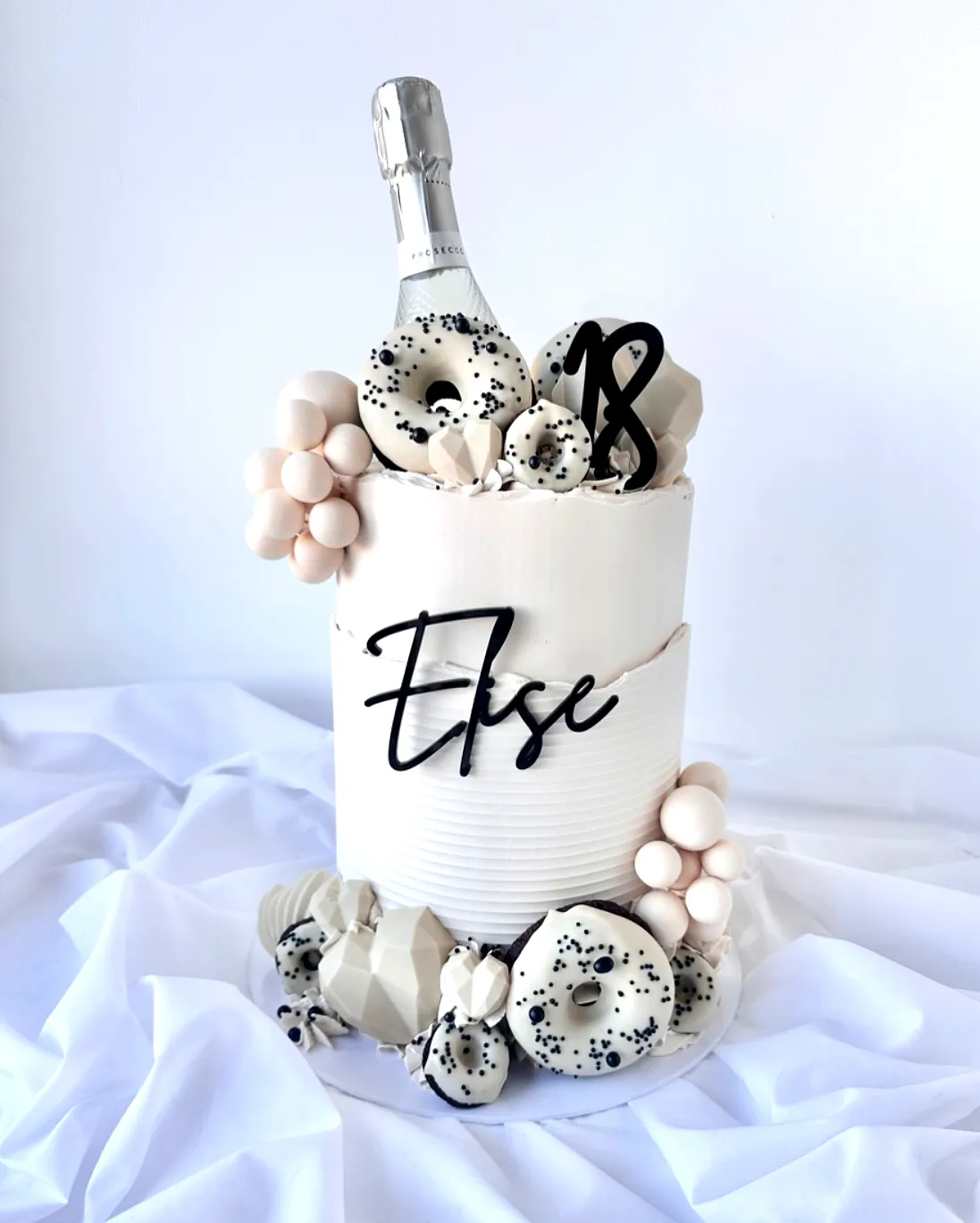 Elegant 18th Birthday Cake with Modern Design and Playful Decorations