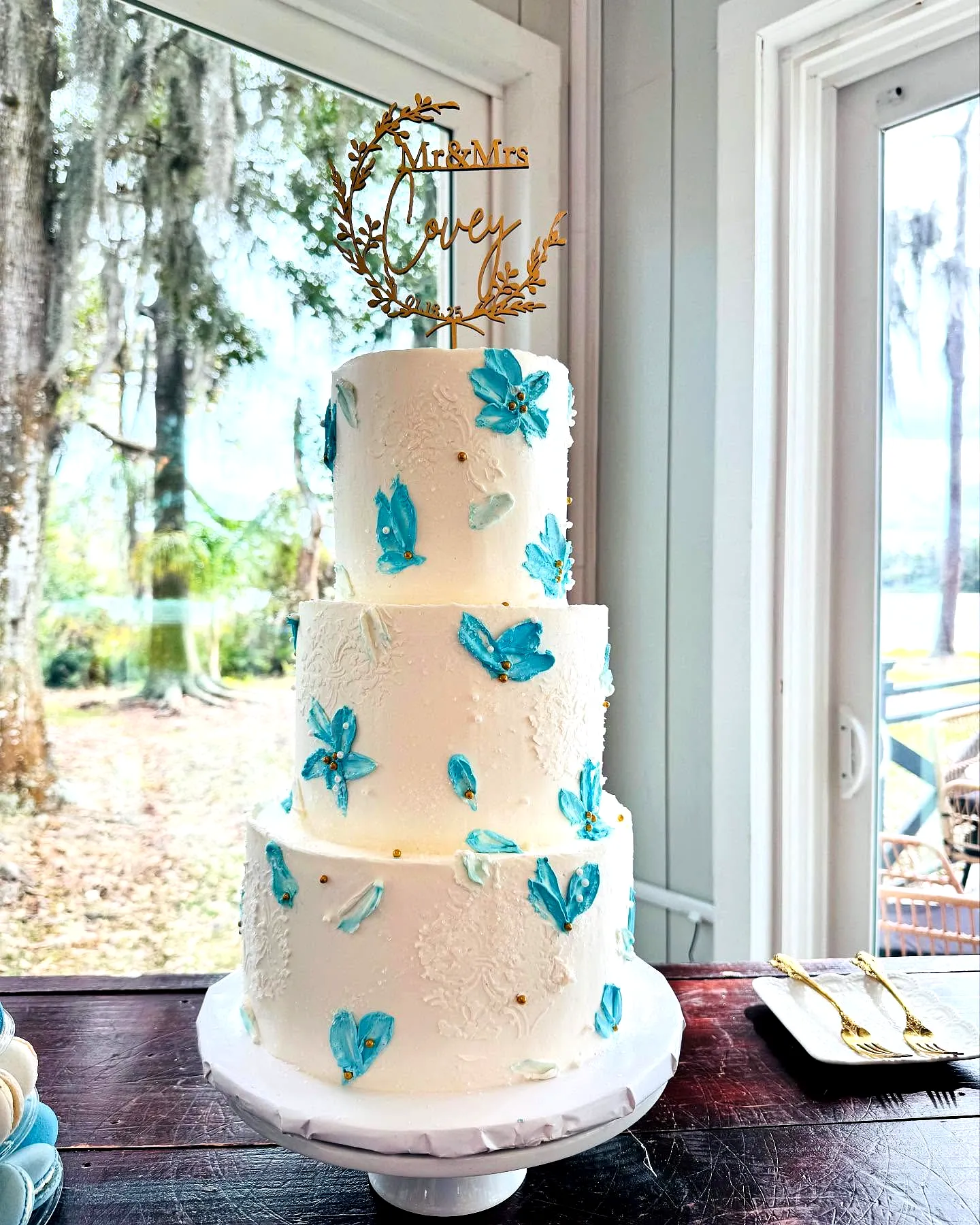 Elegant 3 Tier Wedding Cake Design with Blue Fondant Flowers and Gold Topper