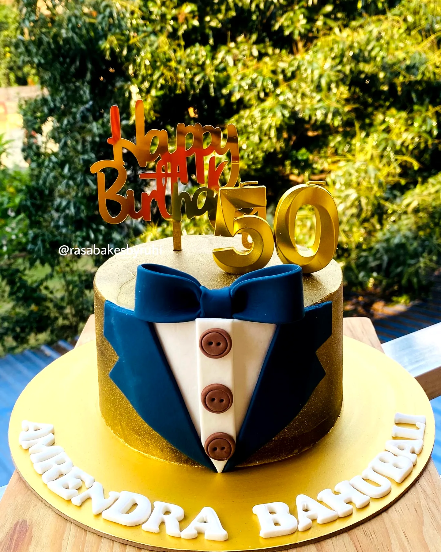 Elegant 50th Birthday Cake for Men in Gold and Navy Tuxedo Design