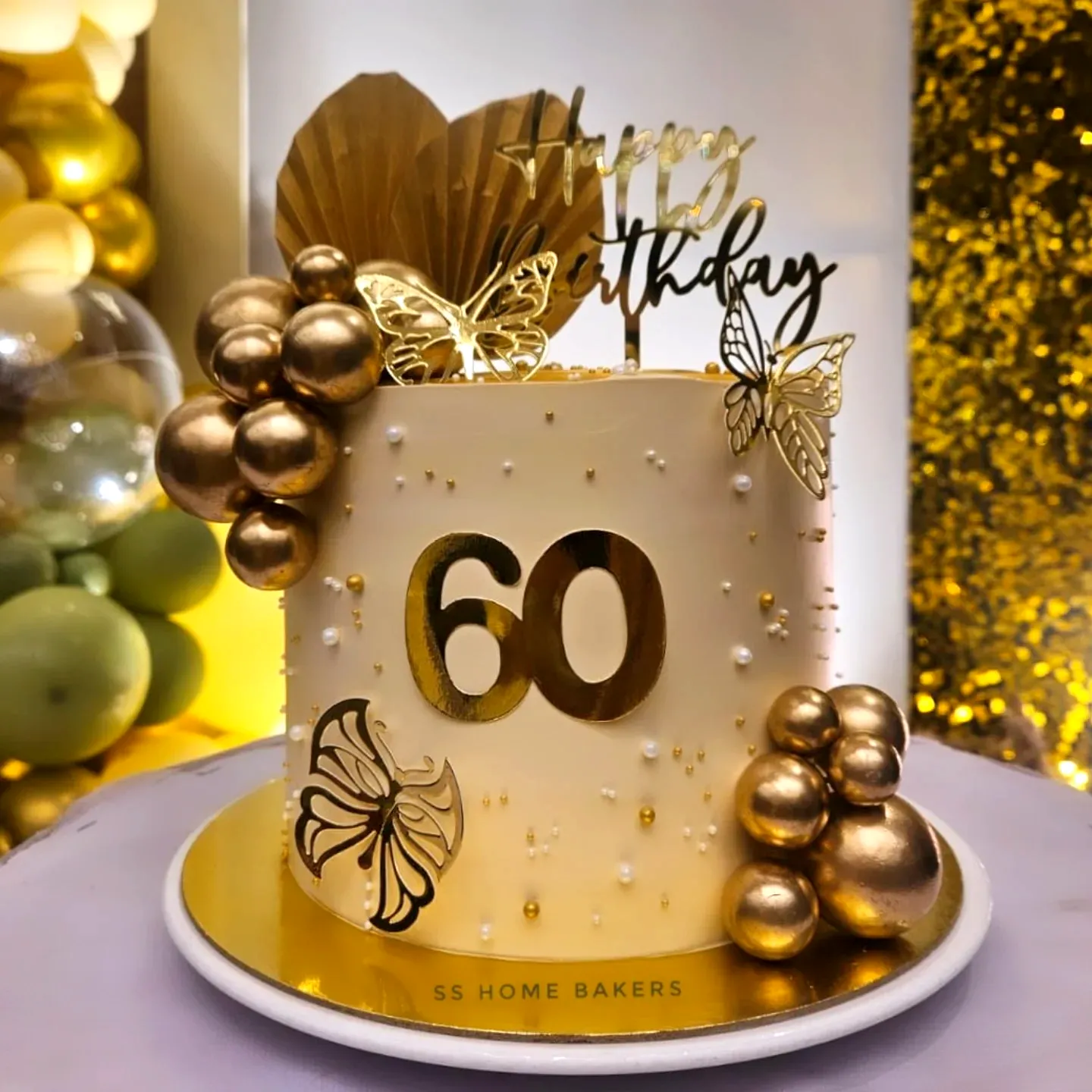 Elegant 60th Birthday Cake Design with Gold Accents and Butterflies
