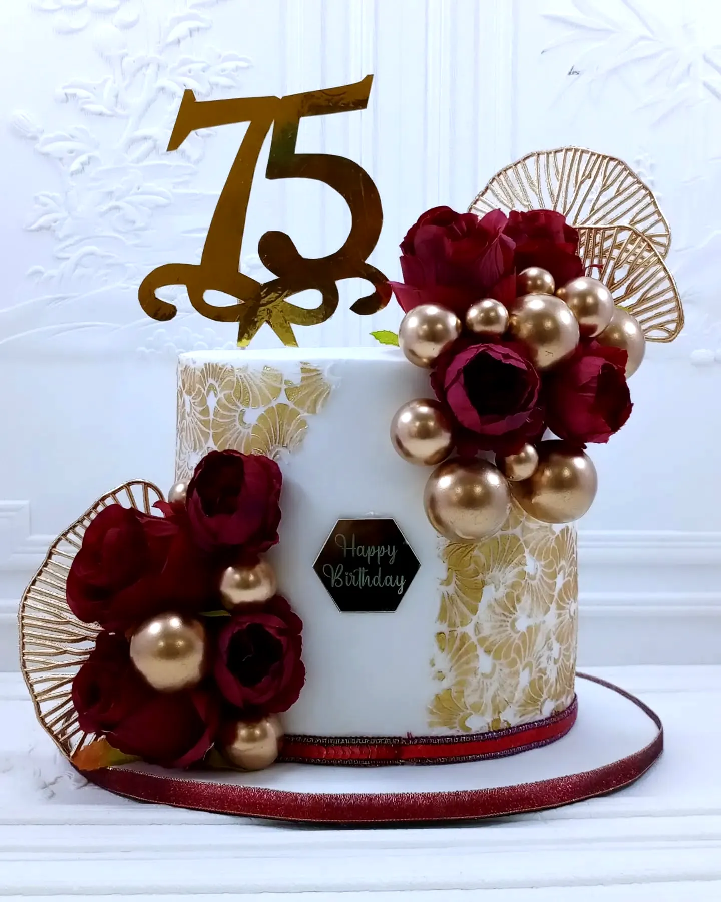 Elegant 75th Birthday Cake Design with Gold and Red Accents